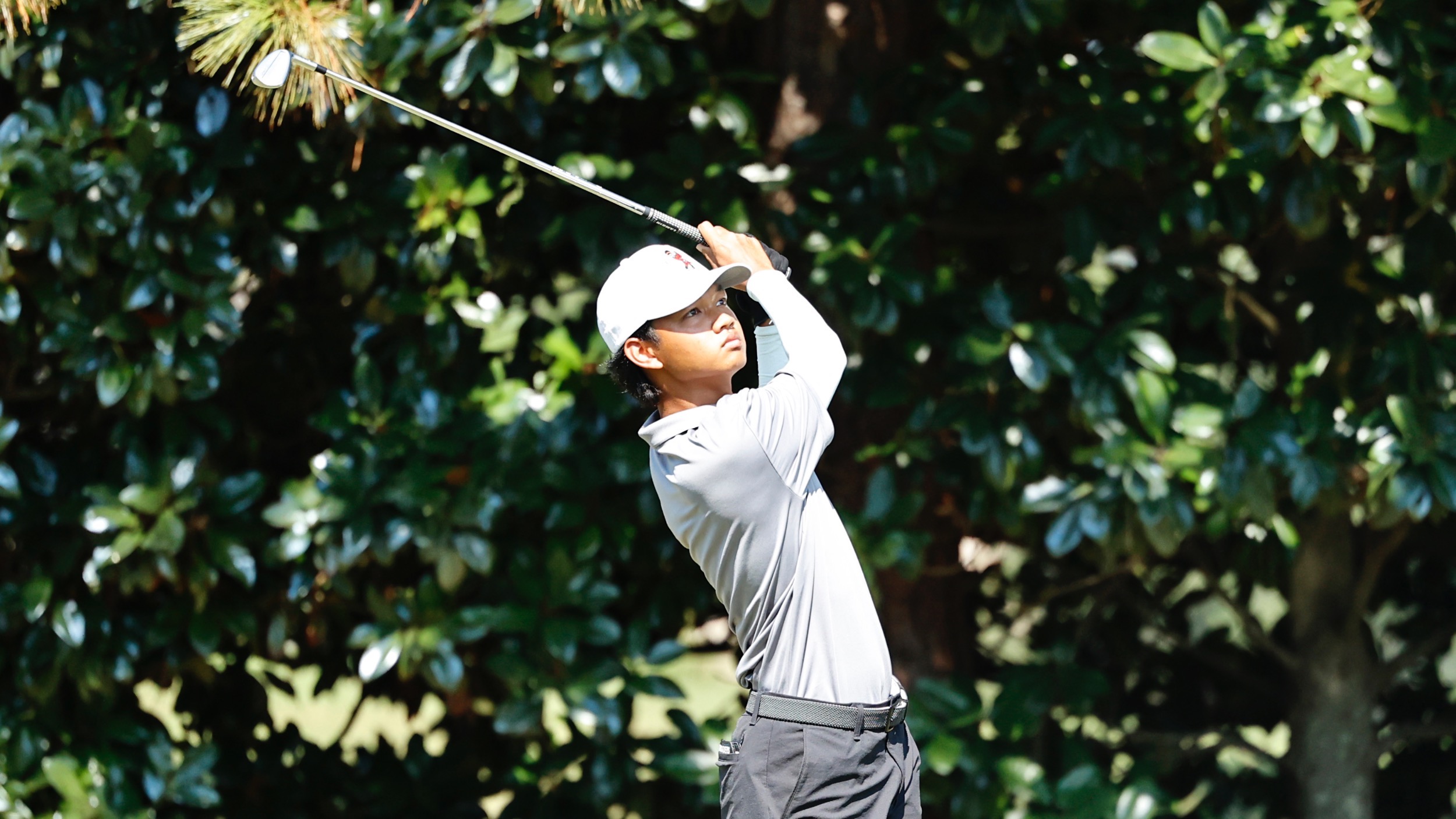 Ongsa Booncharn follows through his swing for the Nicholls Golf team