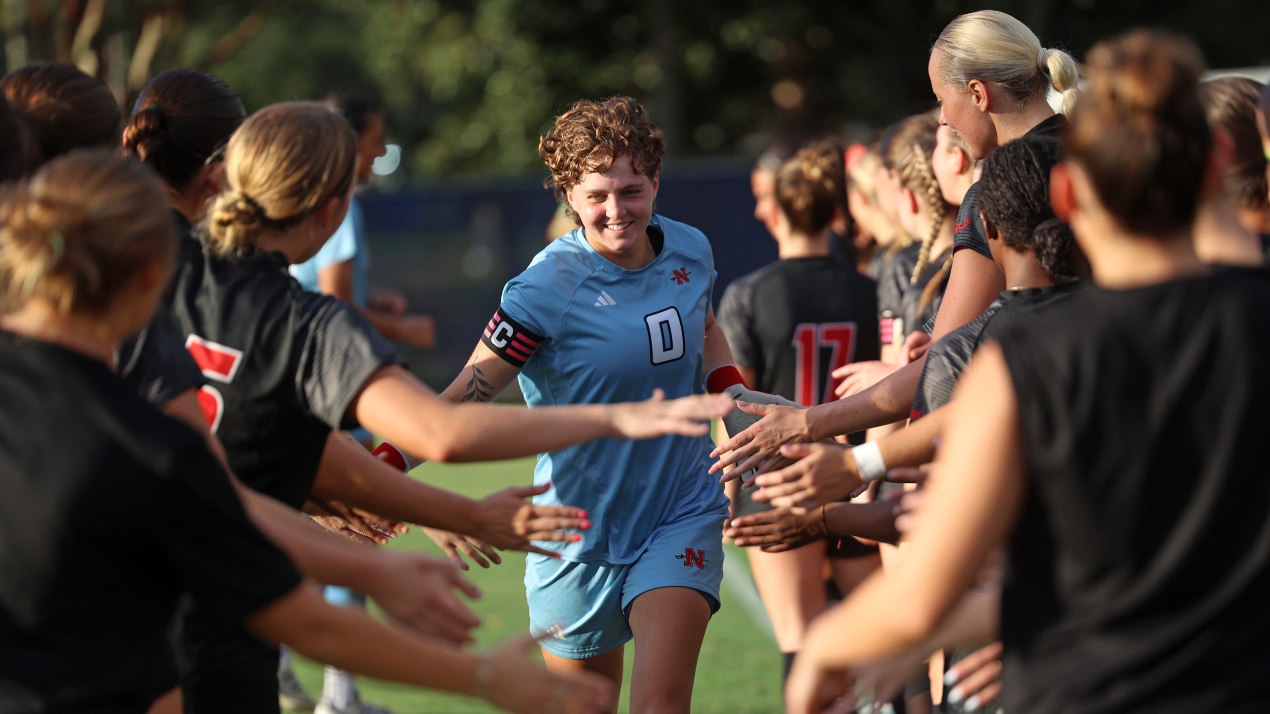 Aislinn Wright high fives teammates during starting lineup