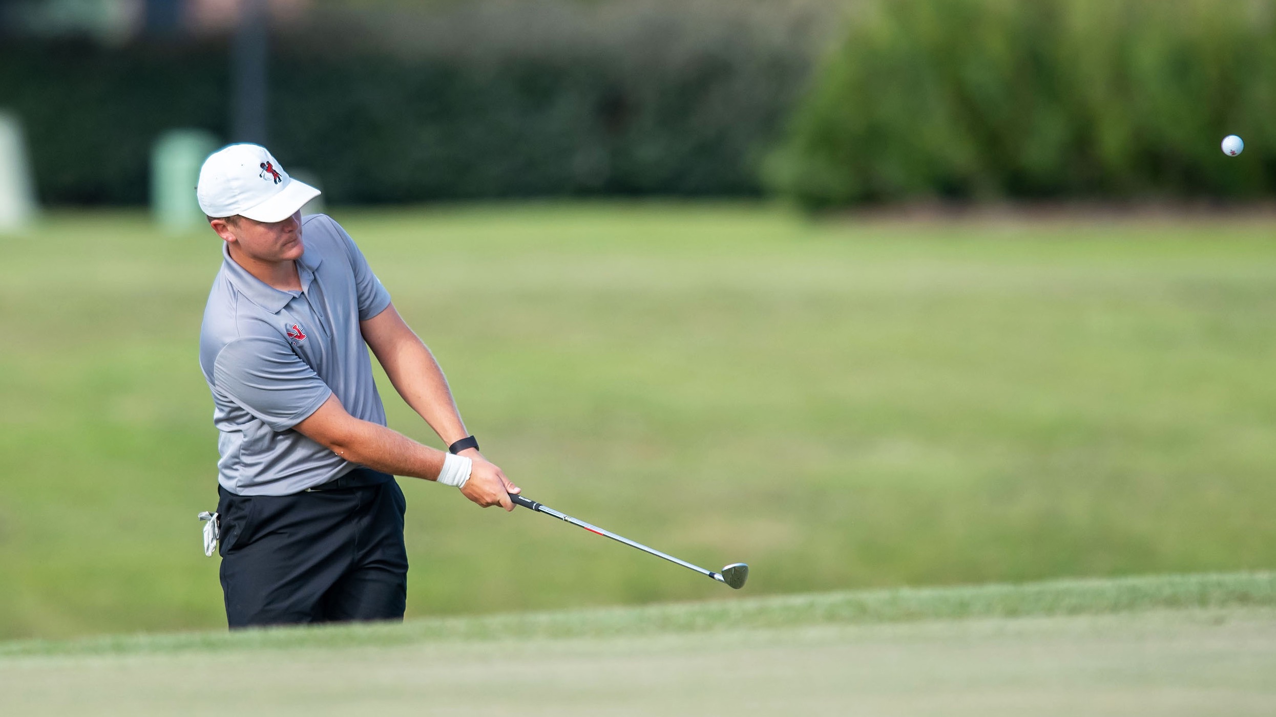 Kyle Traub chips a shot for the Nicholls Golf Team