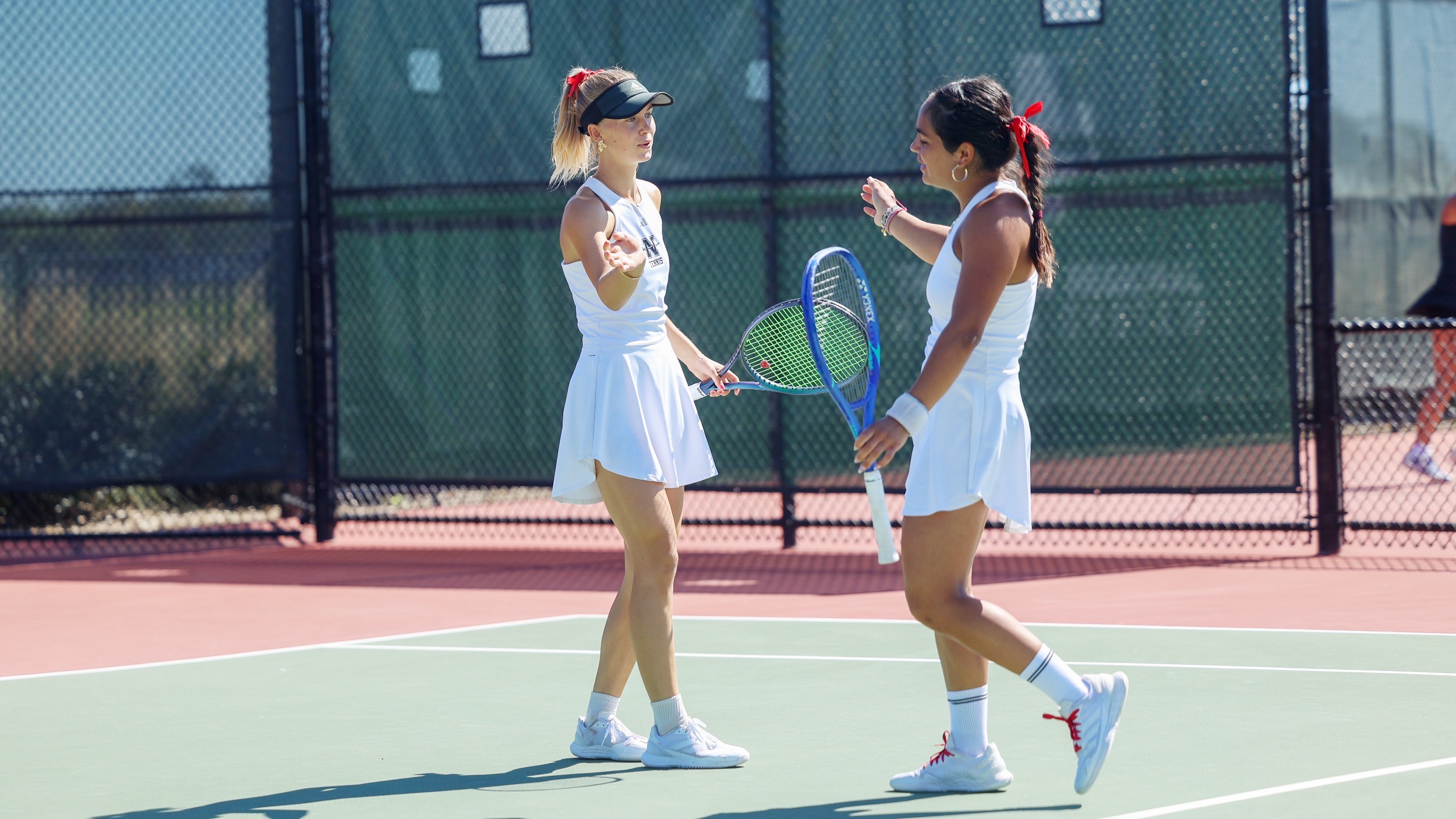 Two Nicholls Women's Tennis Players in Doubles Action