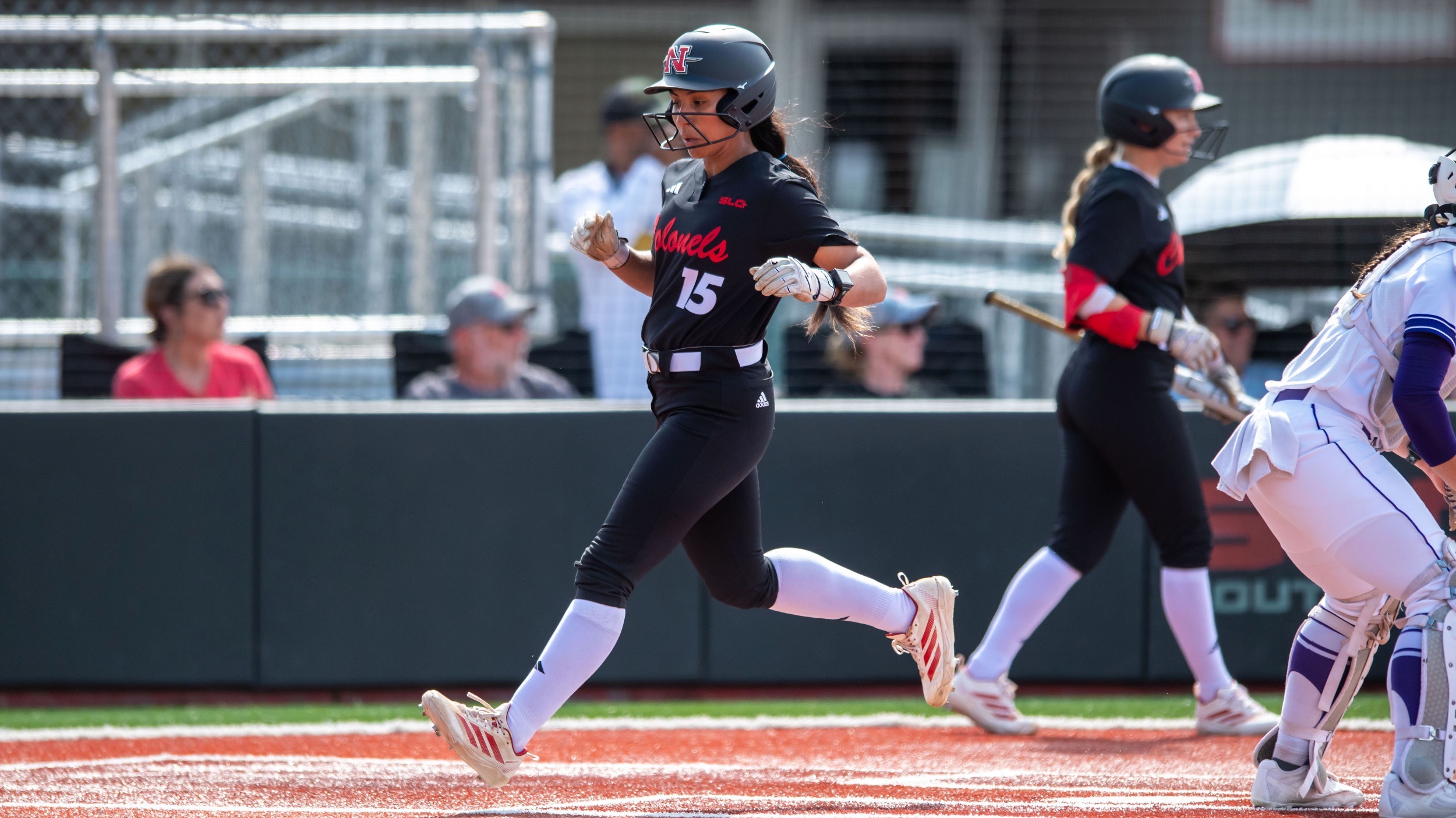 Lilianna Robledo runs across home plate in Nicholls vs SFA softball game