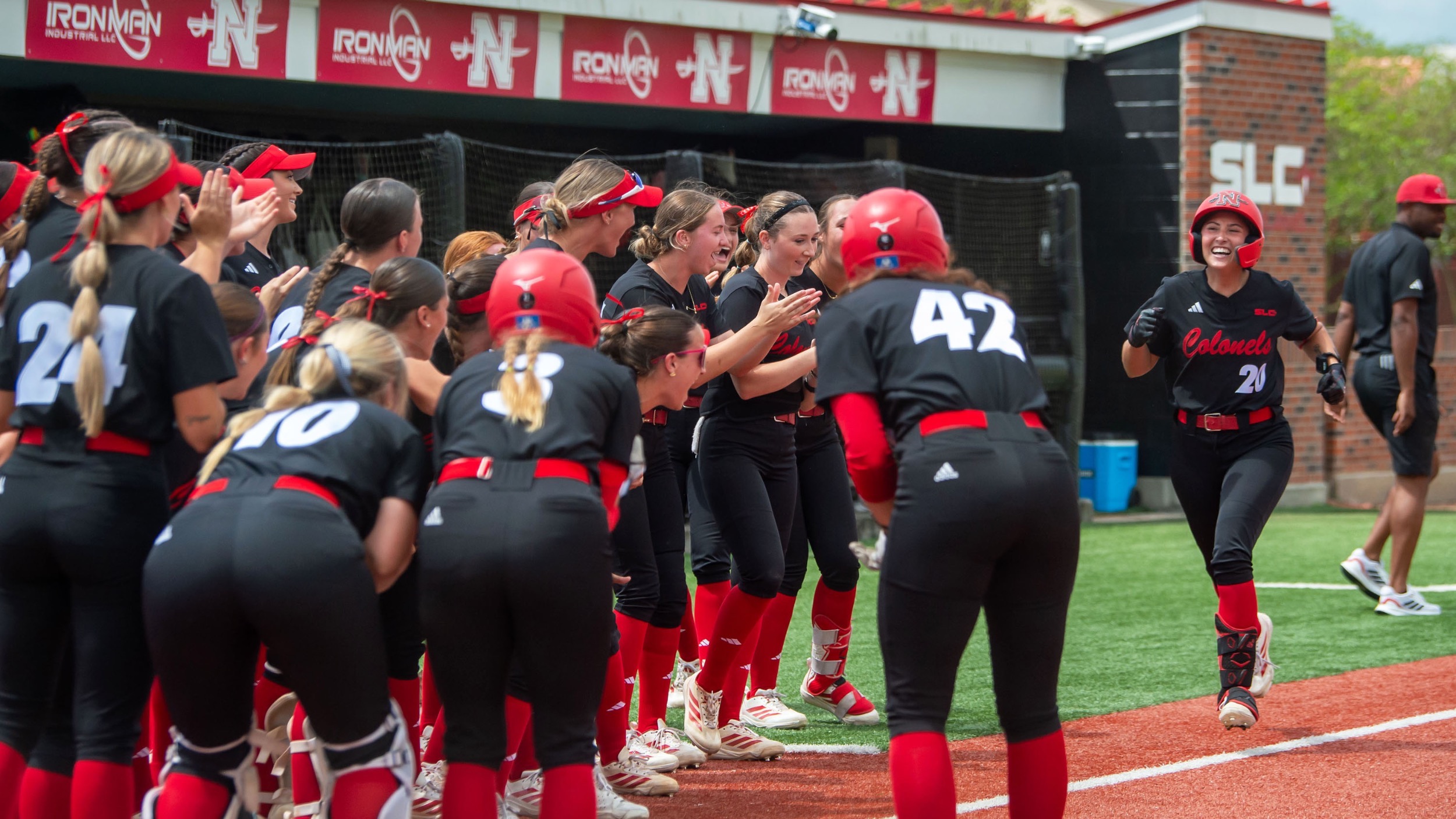 Carmella Muccilli heads towards home plate as her teammates await following her home run