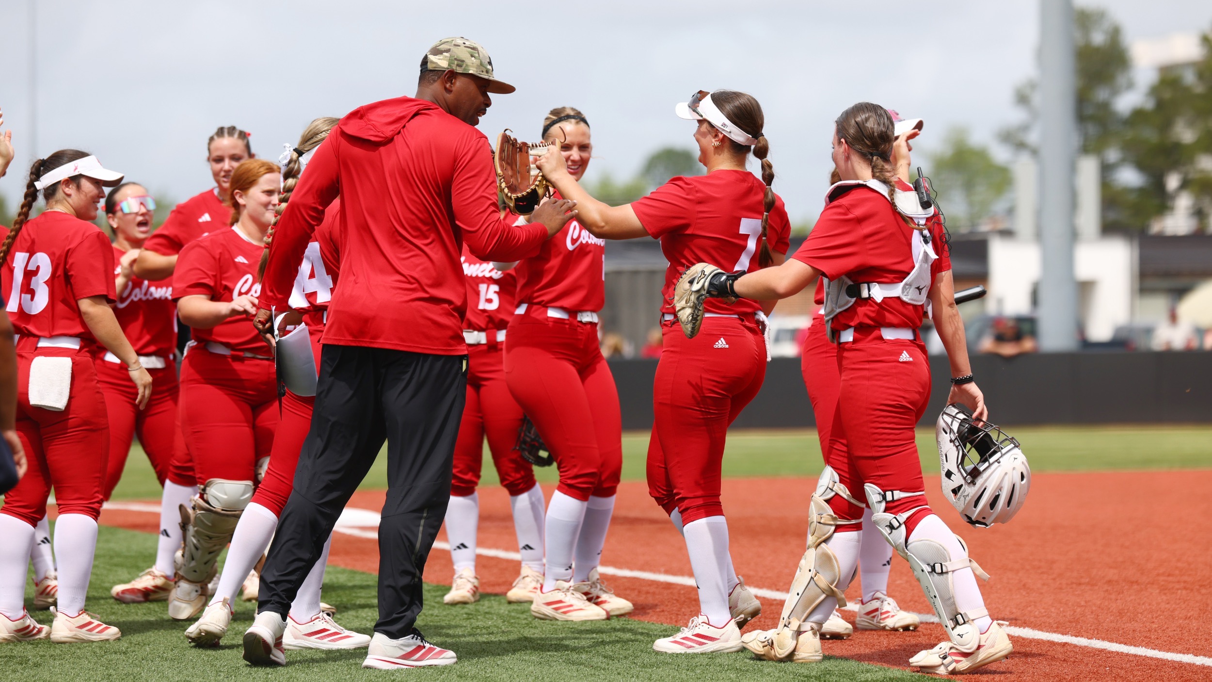 Ron Frost hi fives the Nicholls Softball after getting out of the inning