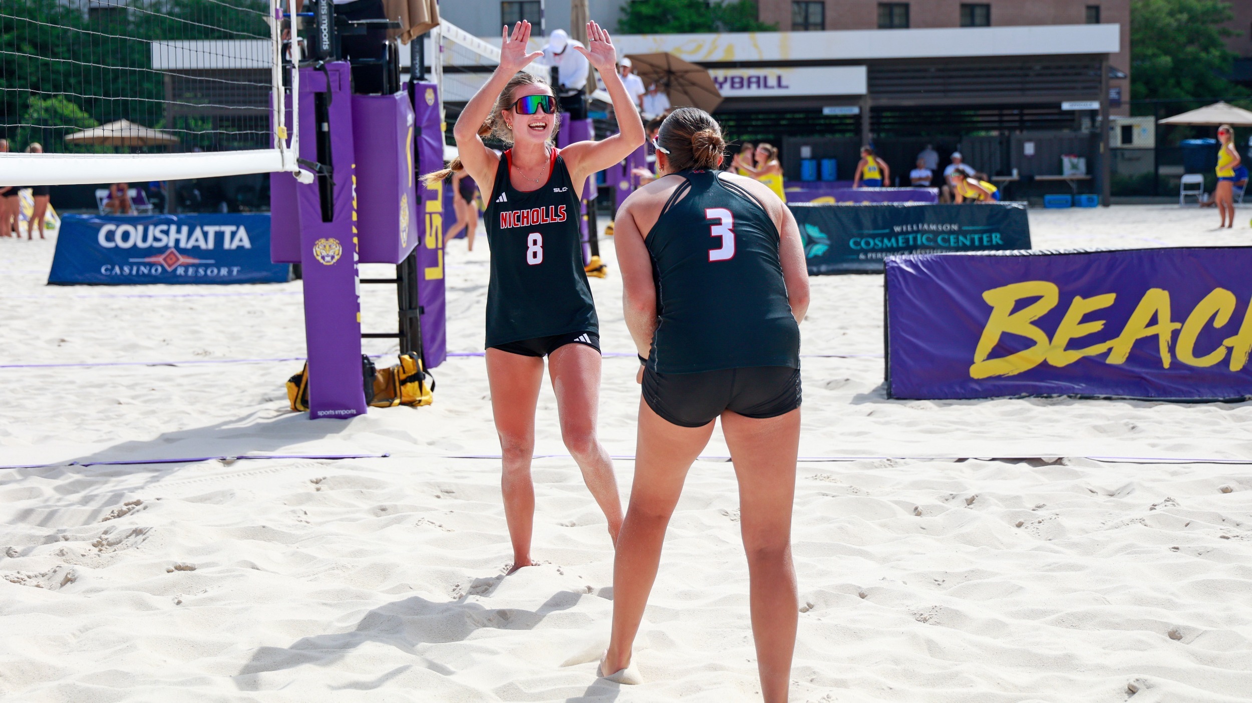 Carly Lang and Brooklynn Wilkinson celebrate a point during Beach volleyball match