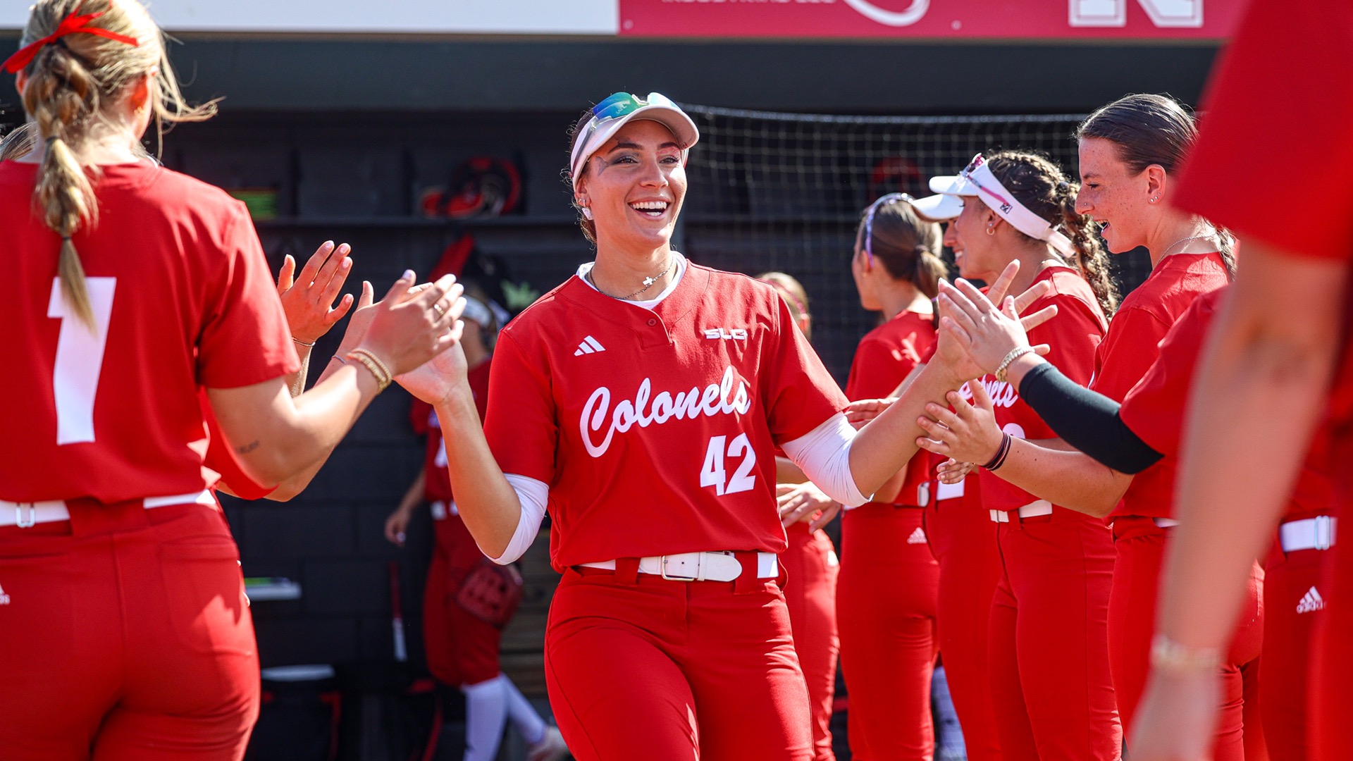 Kayleigh Lugowski hi fives teammates during the starting lineup announcment