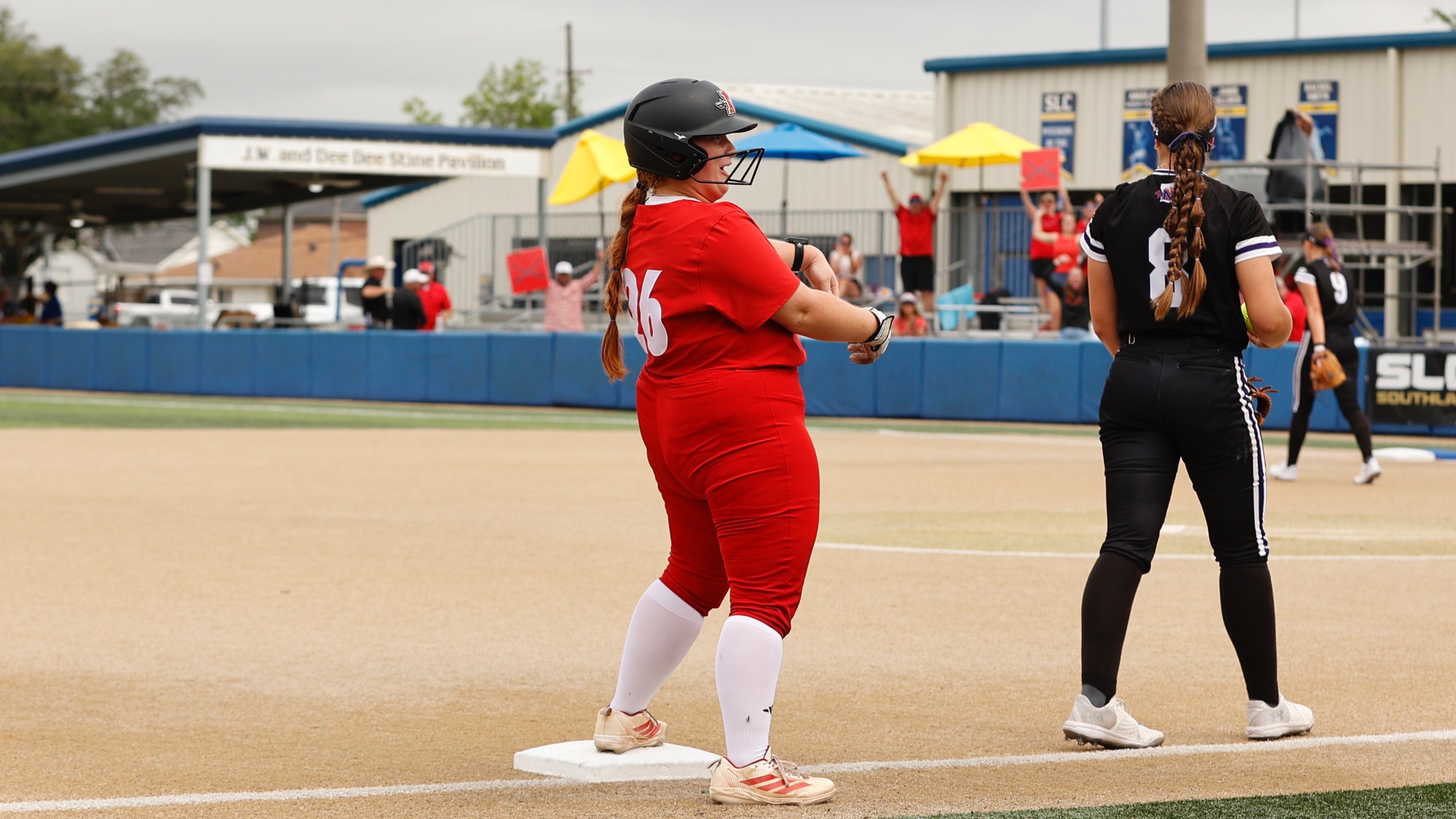 Brynne Songy celebrates after hitting a triple