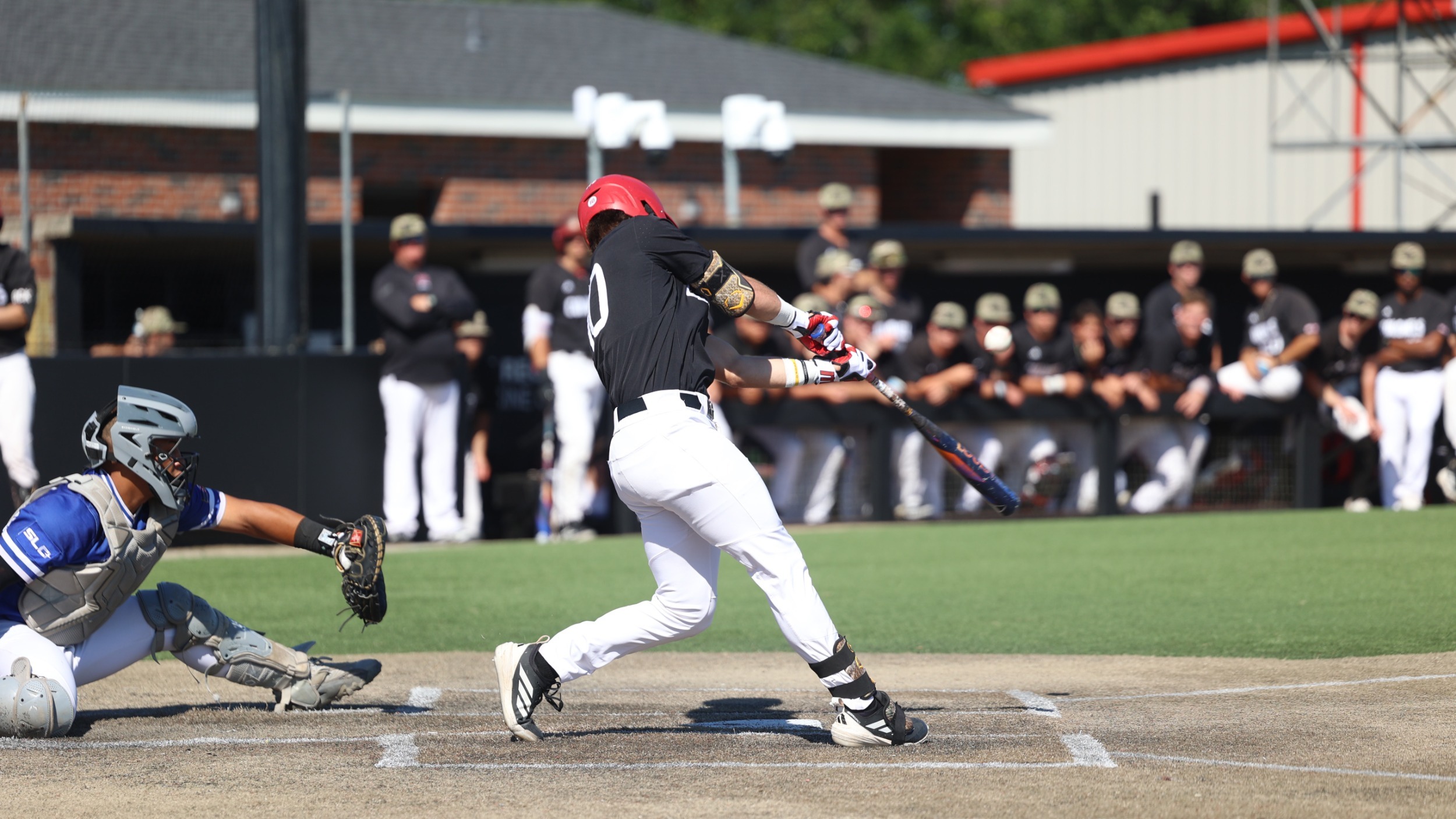 Jaxon Milam hits ball vs UNO