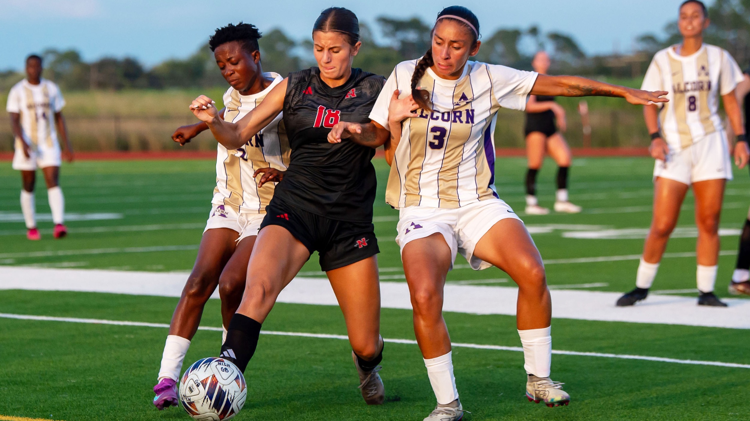 Jezlyn Nelson battles with two soccer defenders from Alcorn