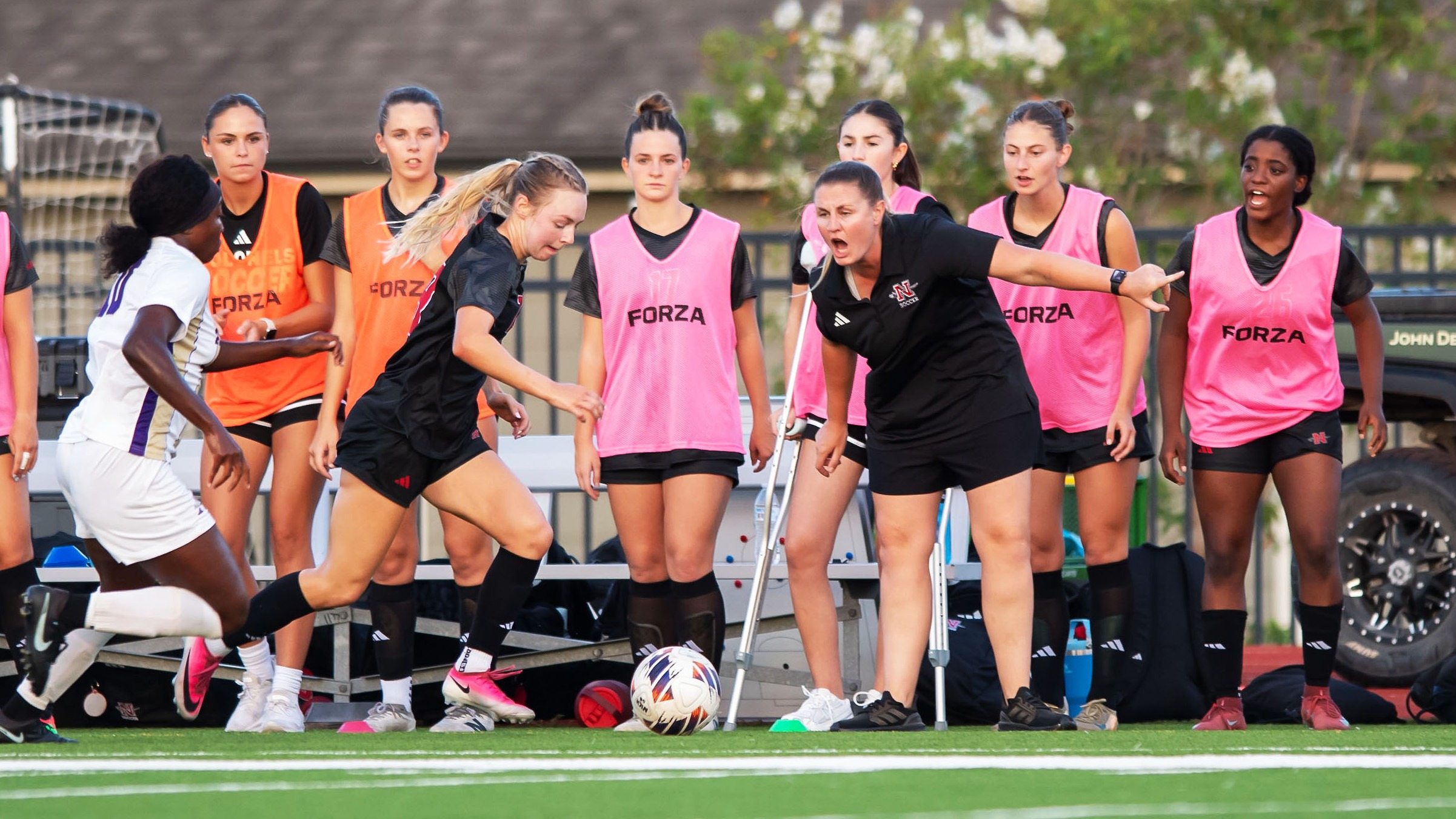 Coach Kristy Helmers Shouts instructions to Oliviya Pugh 