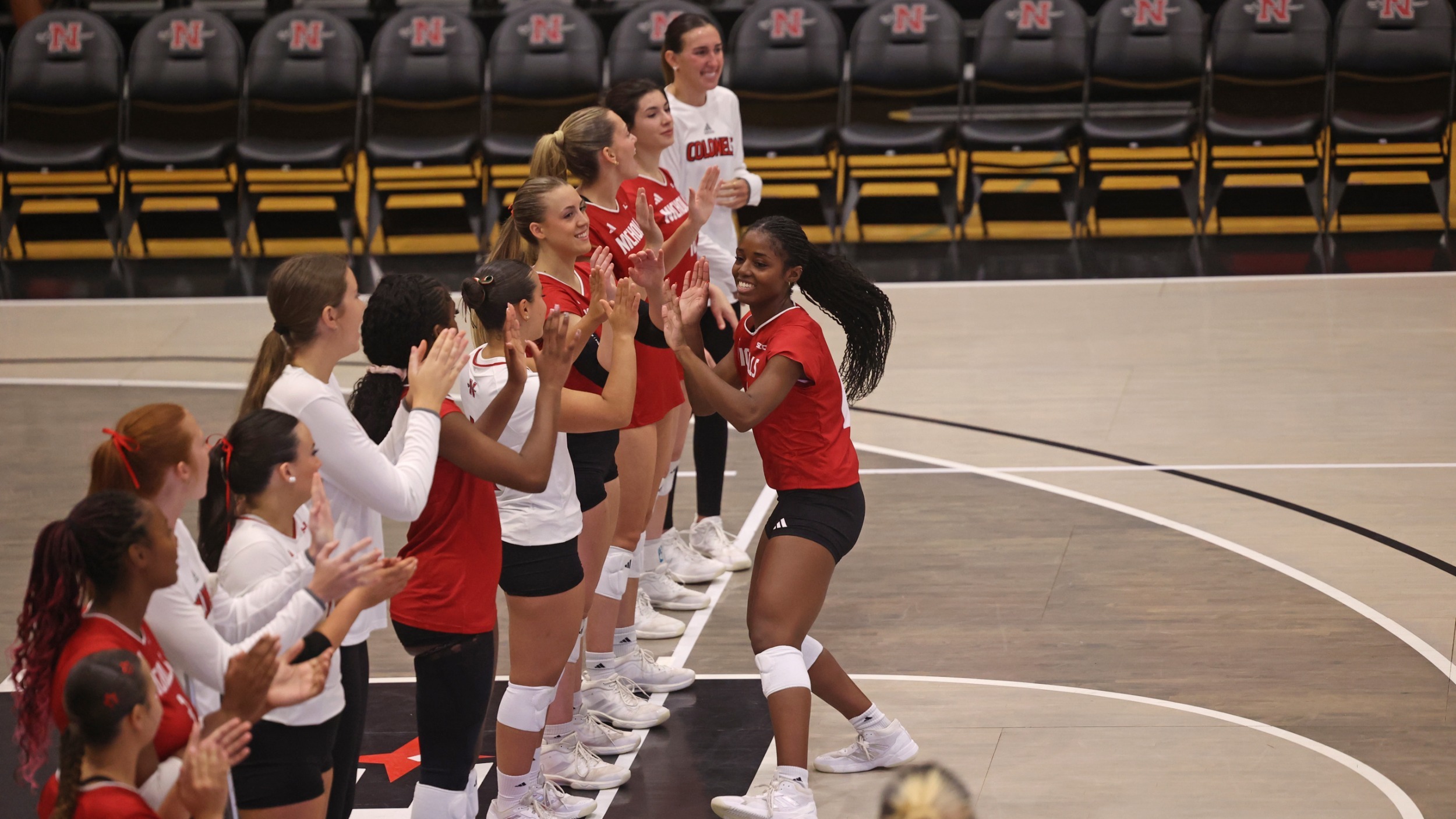 Kera Arrington High 5s teammates during starting lineup announcemetn. 