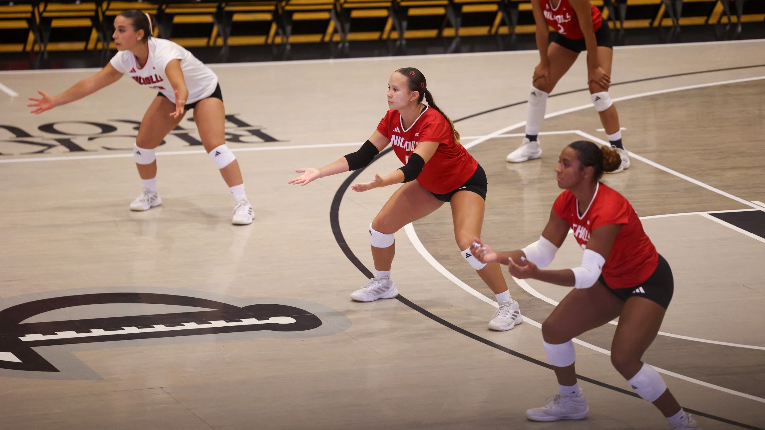 Lizzie Kraft, Tierney Terrell, and Natalia Navarro ready to recieve serve during Nicholls Volleyball match
