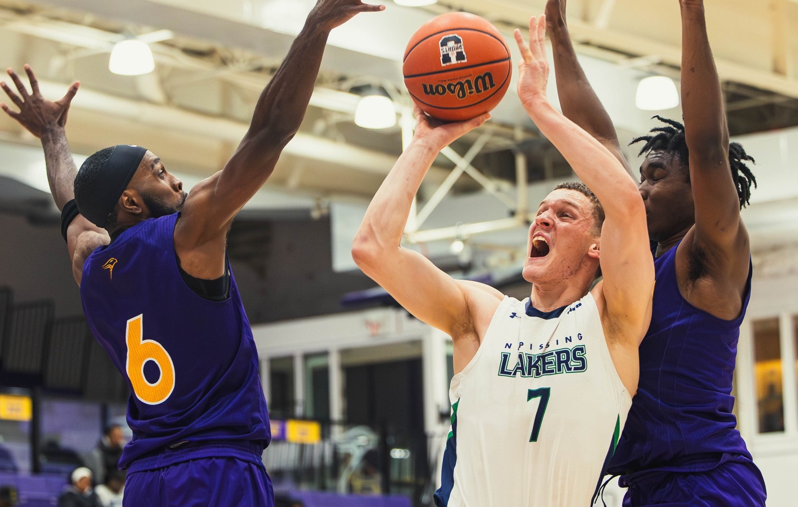 Alex Blackmore fights to score against Laurier