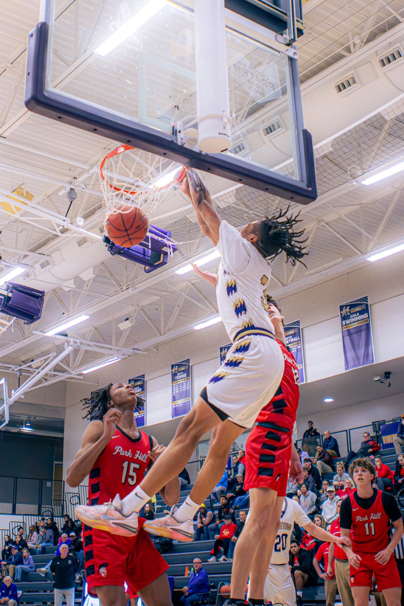 Flying past the defense, Xavius Kirkwood gets the put back dunk.