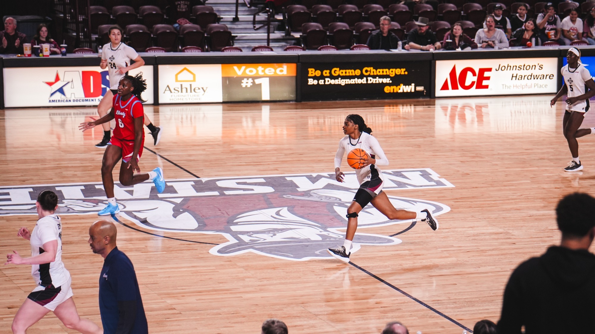 Imani Warren with the basketball near half-court against Liberty (1/2)