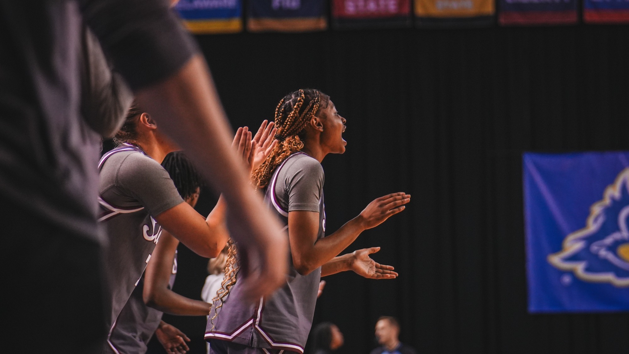 Imani Warren celebrating a made basket on the bench against Delaware (2/12)