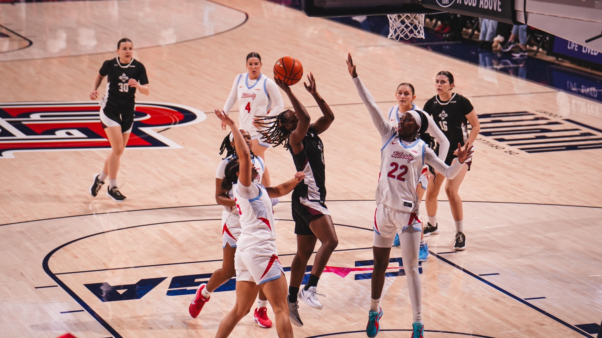 Dee Wilson driving the lane for a shot against Liberty (2/14)