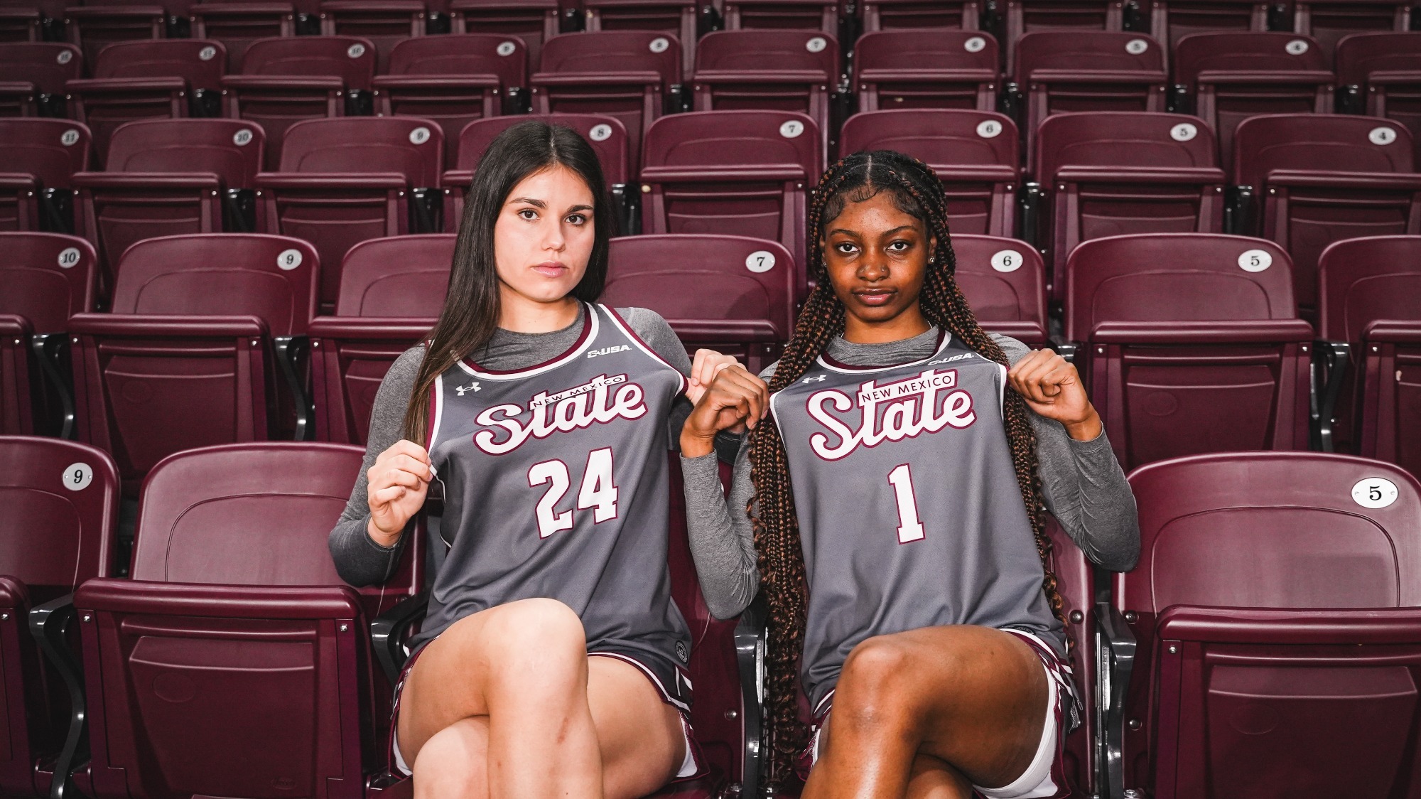 Imani Warren and Lucía Yenes sitting in the stands at the Pan American Center \