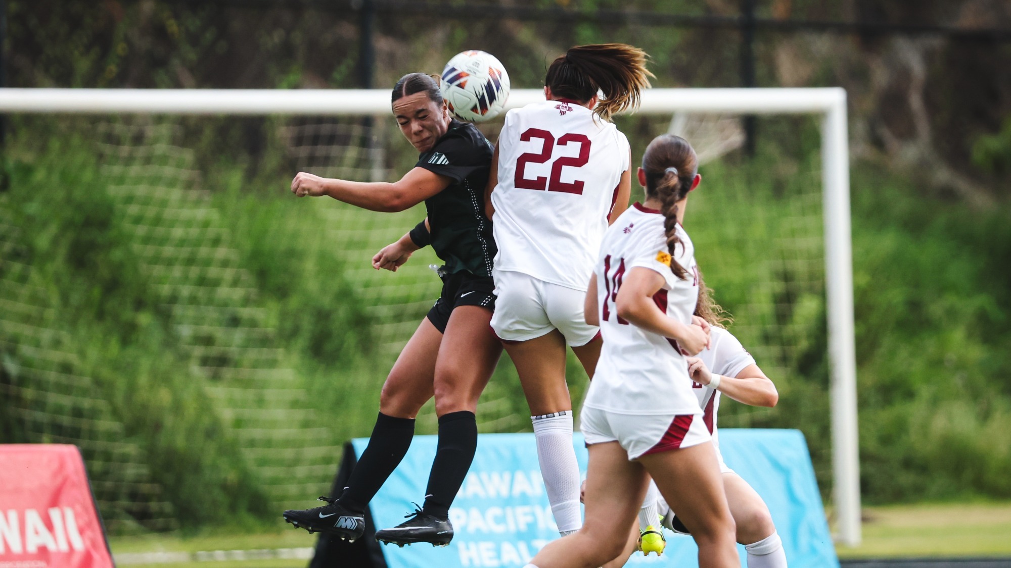 Kennedy Herrera battling for a ball in the air against Hawaii (9/3)