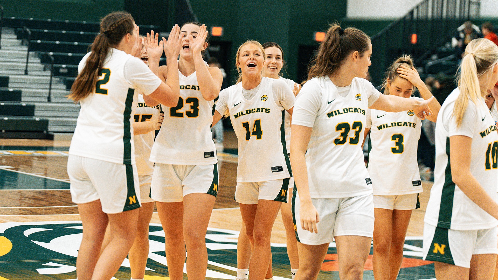 Women's basketball team celebrates a win