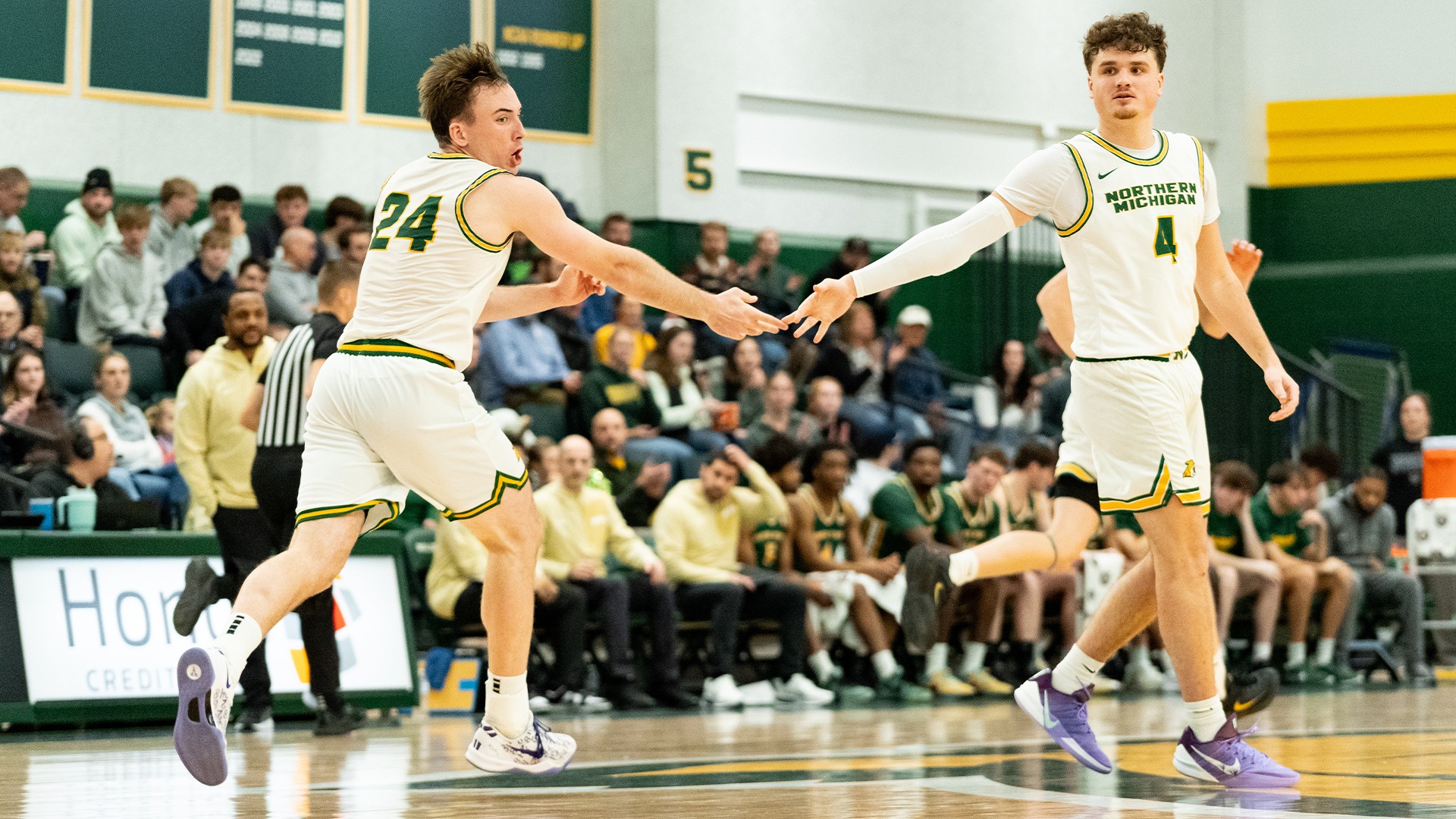 Bennett Basich and Cal Klesmit high five