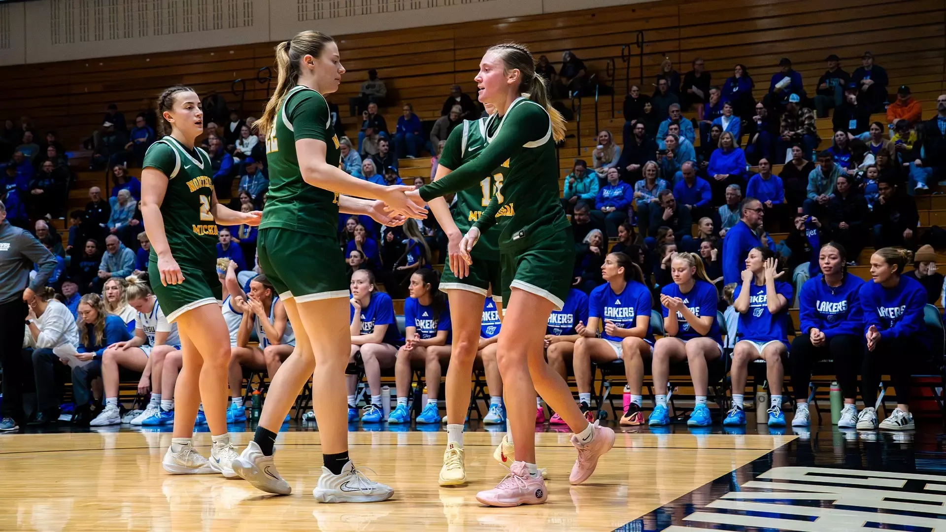 Wildcats come together after a play at GVSU