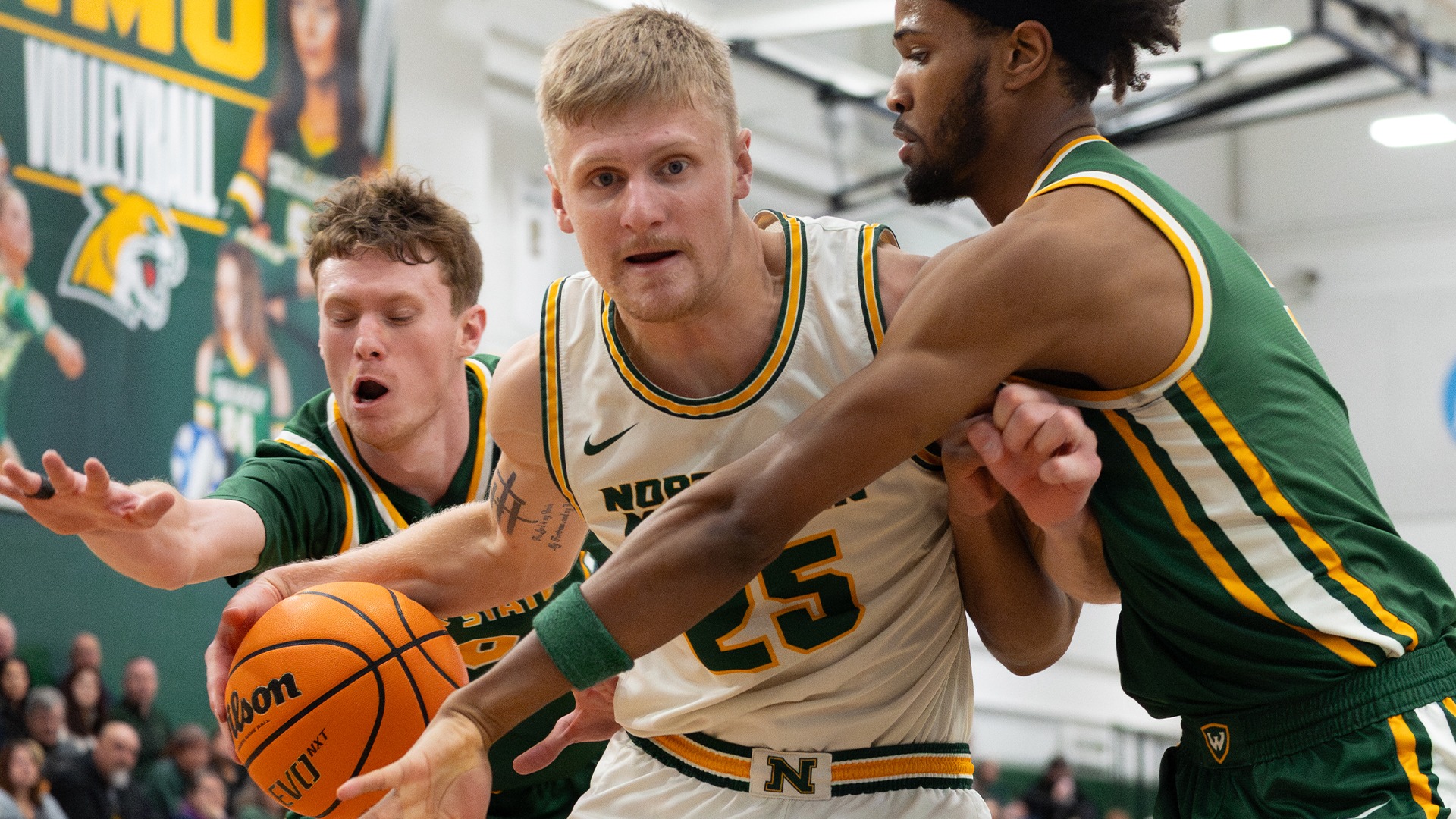 Dylan Kuehl between Warrior defenders