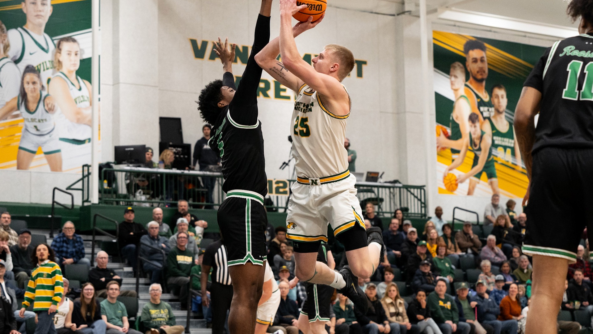 Dylan Kuehl shoots a contested jumper over a defender