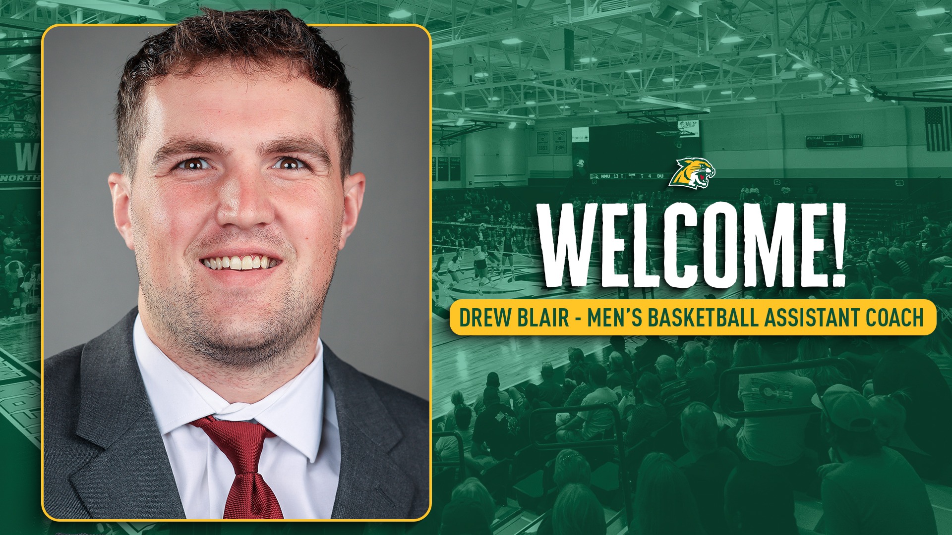 A horizontal digital banner for Northern Michigan University athletics featuring a headshot of Drew Blair on the left side, dressed in a professional grey suit and maroon tie. The right two-thirds of the image shows a green-tinted, blurred wide shot of a crowded basketball arena with the Wildcats logo positioned above the prominent white text 