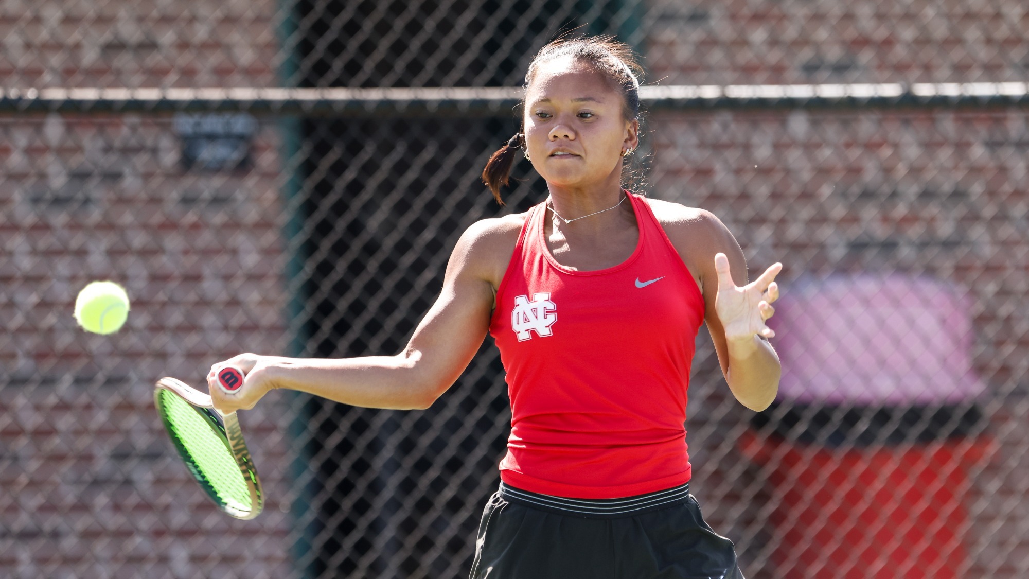 Abigail Penados receiving a serve in the middle of a practice match.