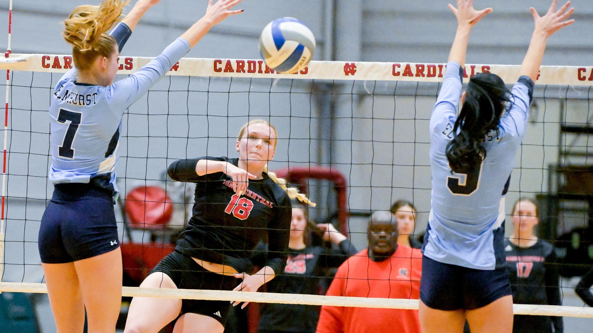 Lauren Benson spiking the ball over the net