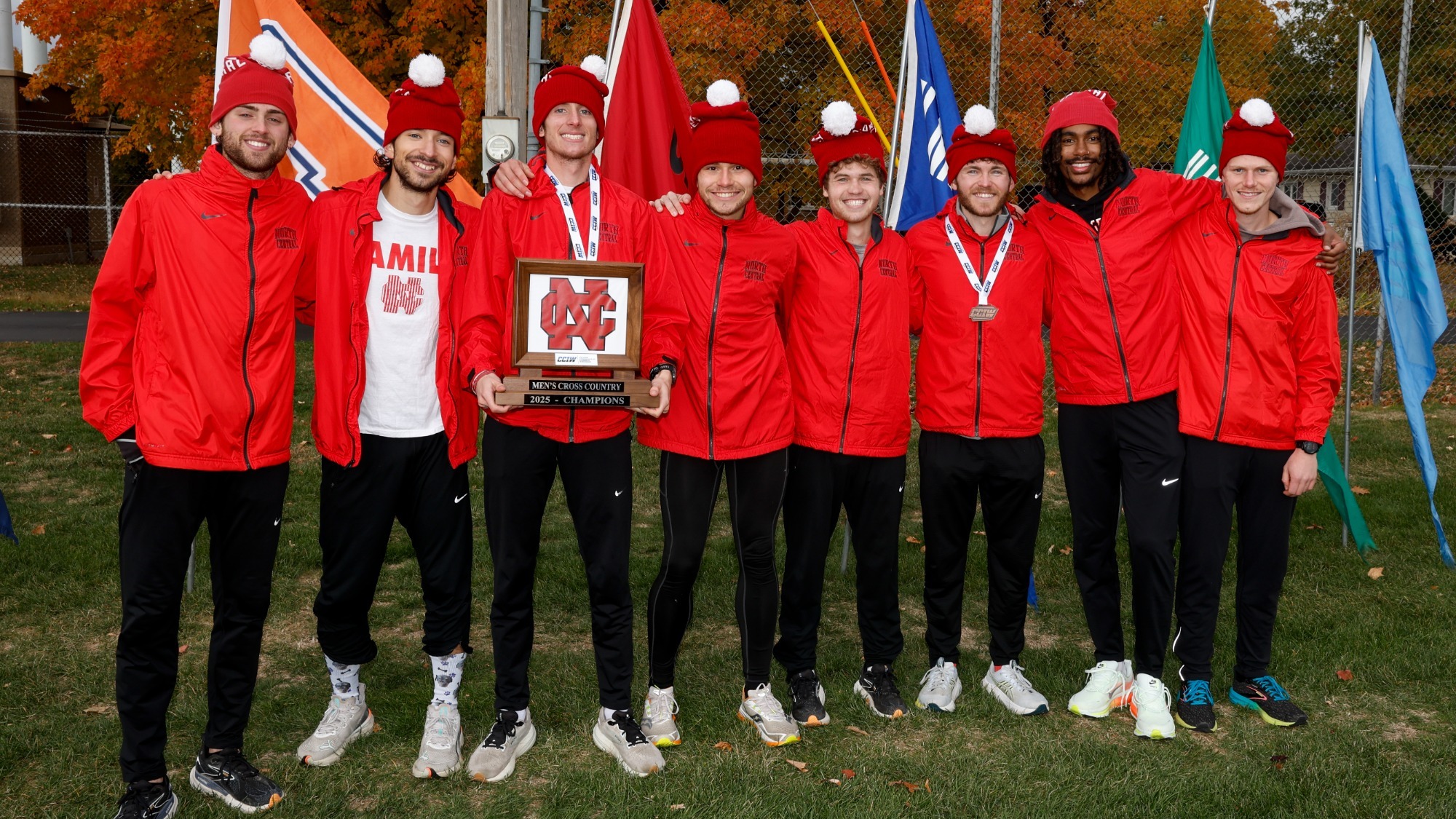 Men's cross country seniors with CCIW Championship trophy