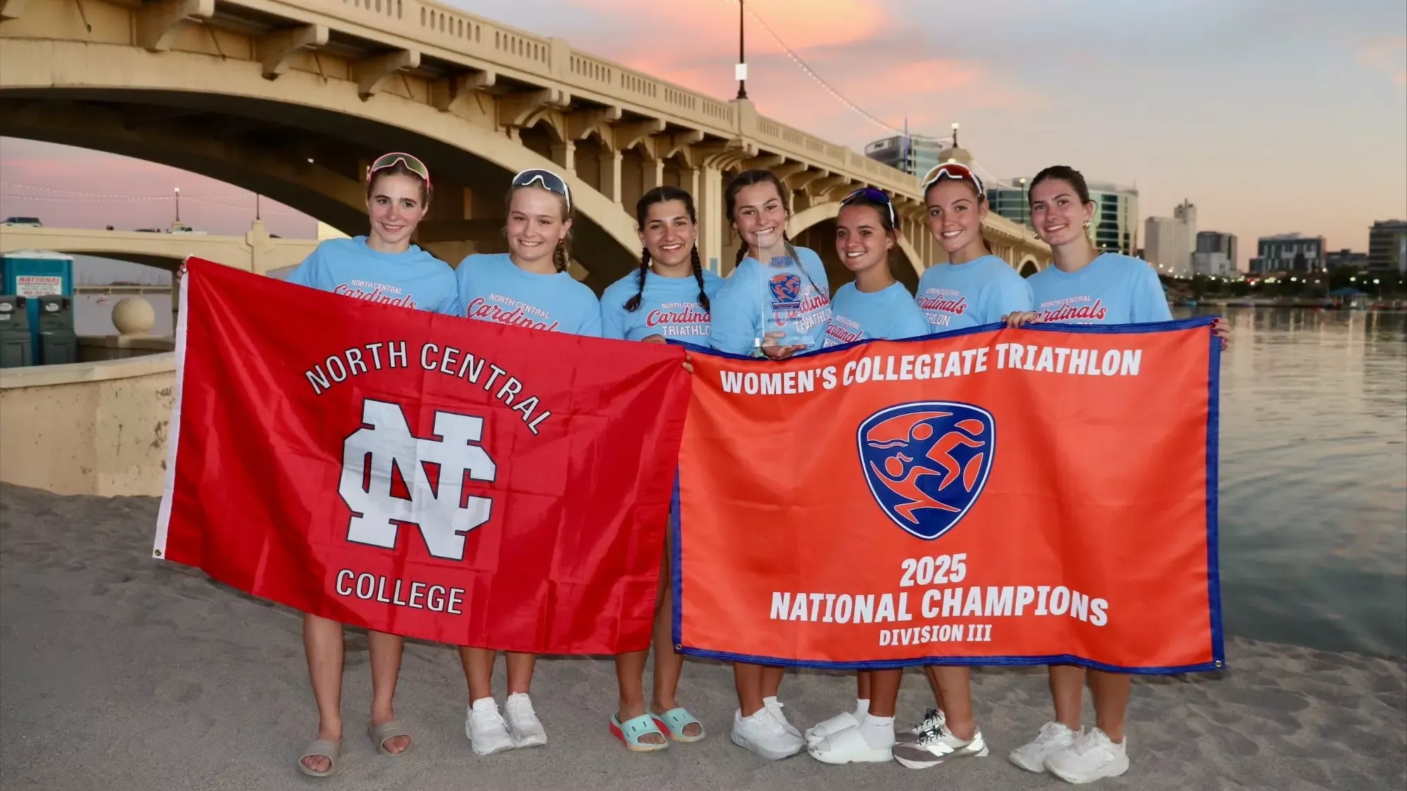 The North Central College women's triathlon team posing with their trophy after winning the 2025 USA Triathlon National Championship.