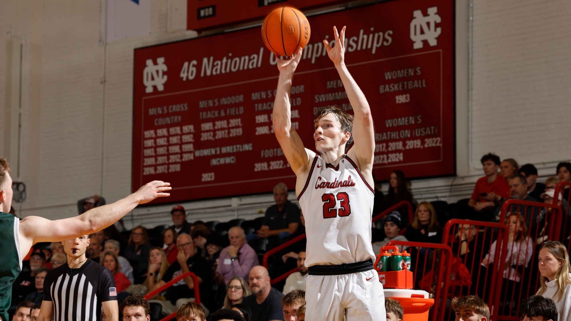 Sean Molloy shoots over a defender in the corner while the North Central bench watches on.