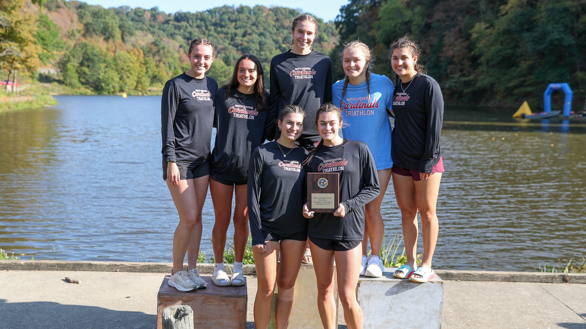 North Central College women's triathlon posing with their fifth place overall plaque at the Beaver County Tri Cup