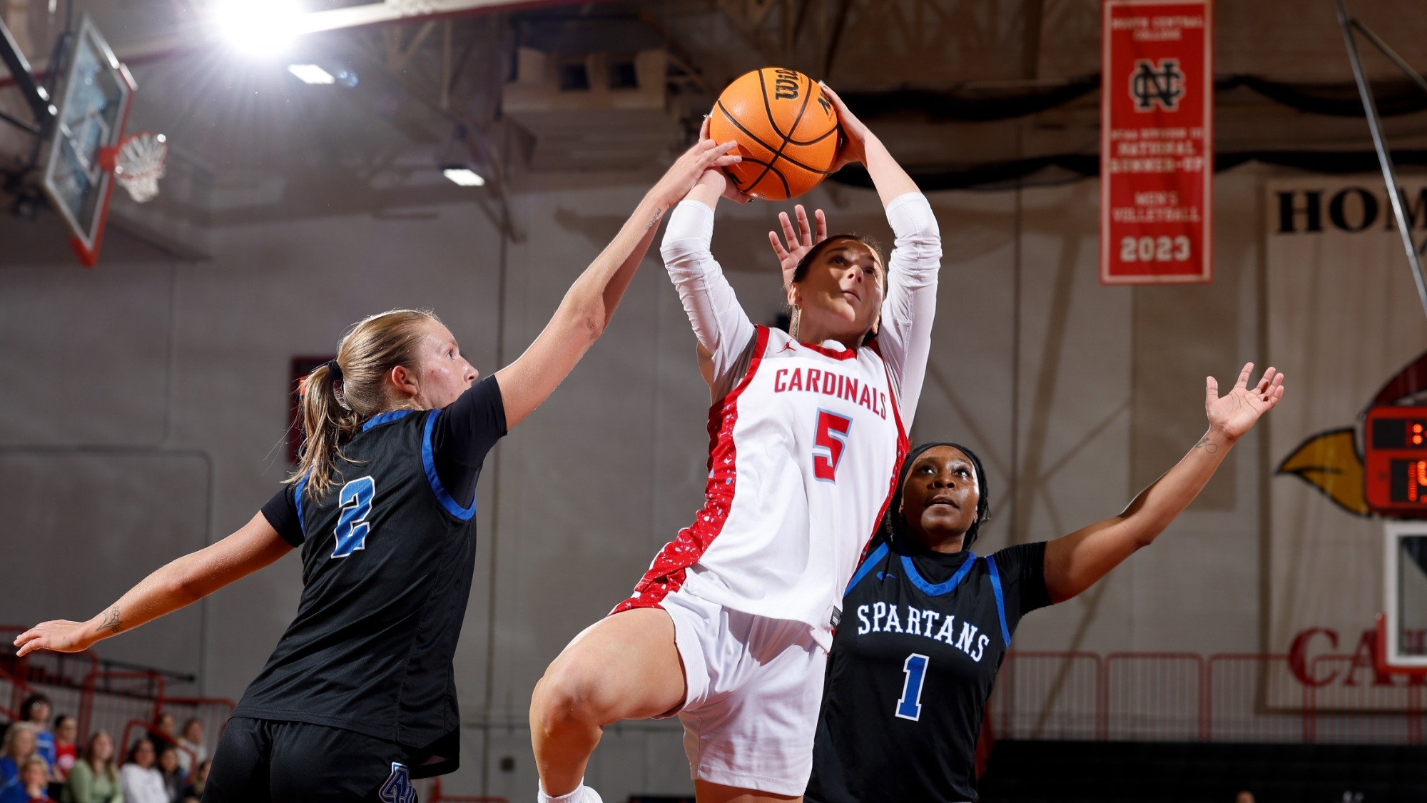 Grace Kieffer going up for a layup against two Aurora defenders on Dec. 30, 2025.