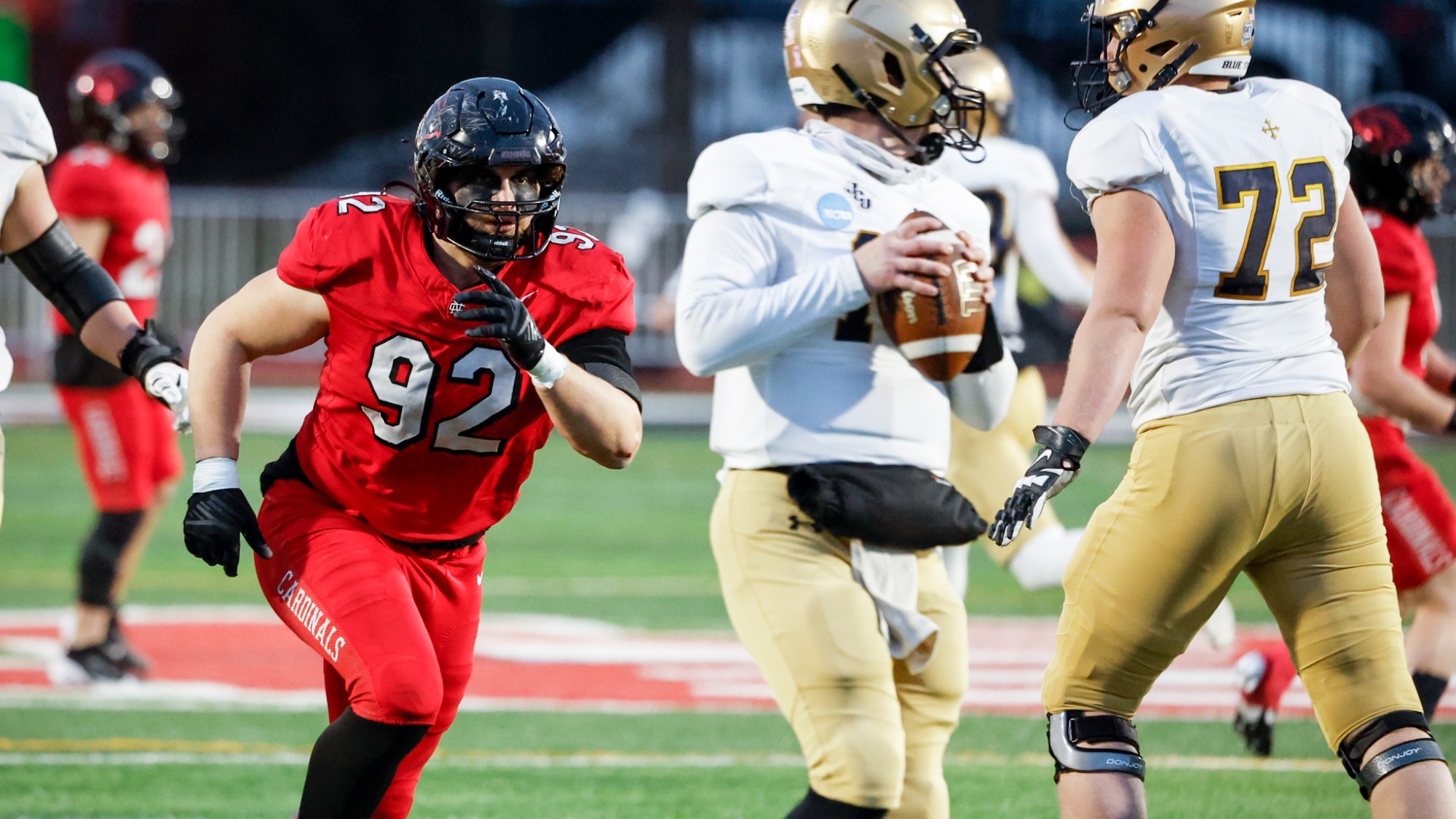 John Sullivan rushing the John Carroll quarterback