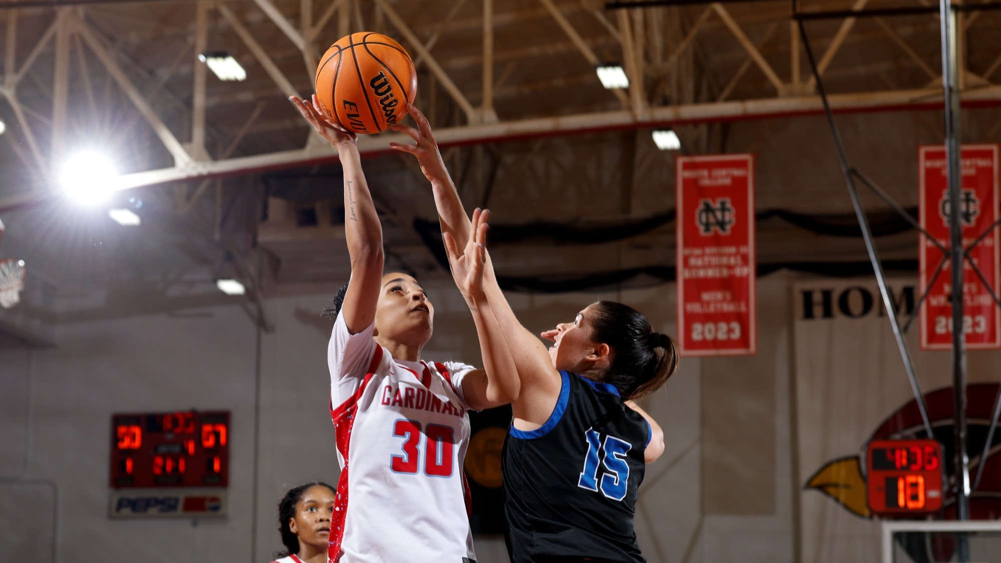 Alaya Redditt going up for a layup against her Aurora defender on Dec. 30, 2025.