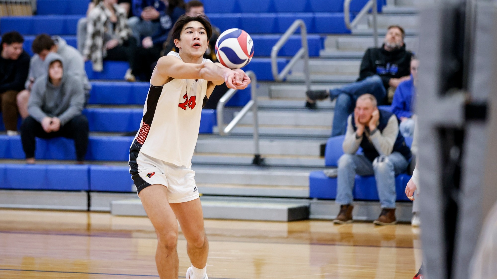 Chris Mactal digs an attack of an opponent with two arms extended.