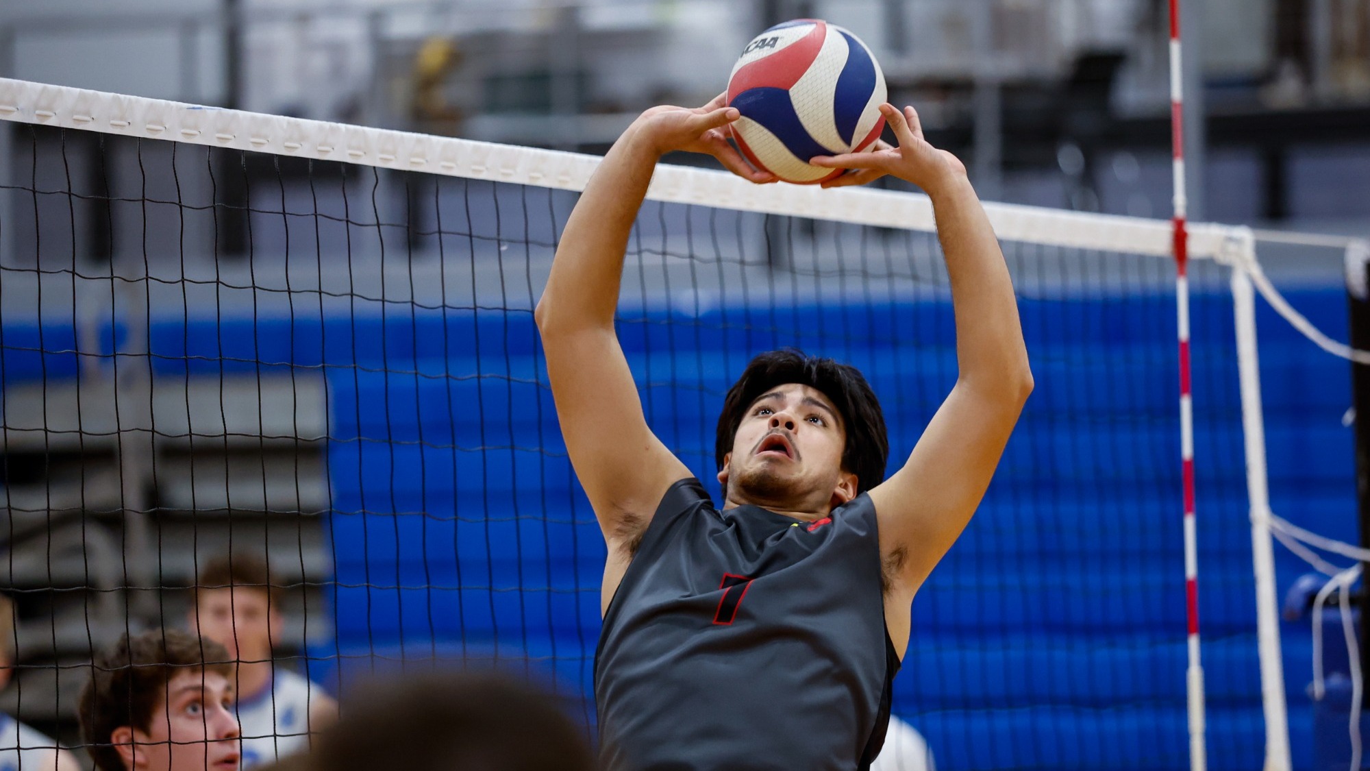 Angelo Delgado sets to a player behind him