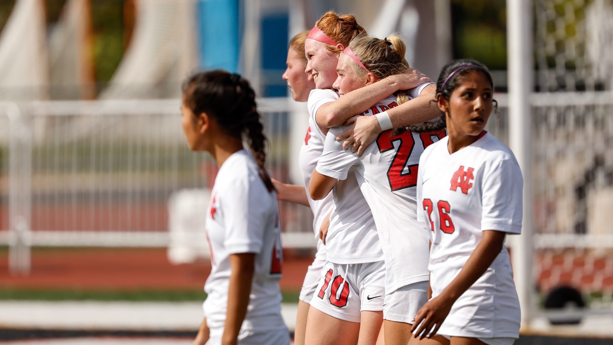 Reese Anderson and Kara Waishwell embrace after goal against Carroll