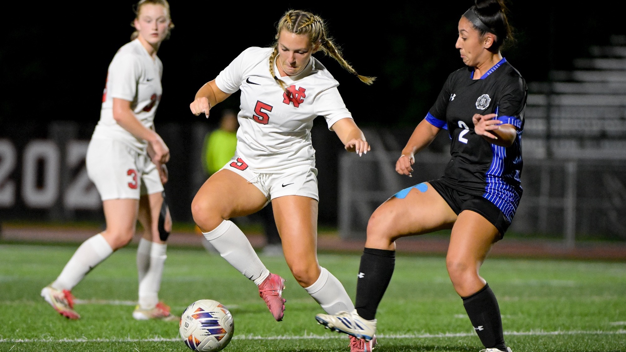 Lily Mayer battles defender for possession