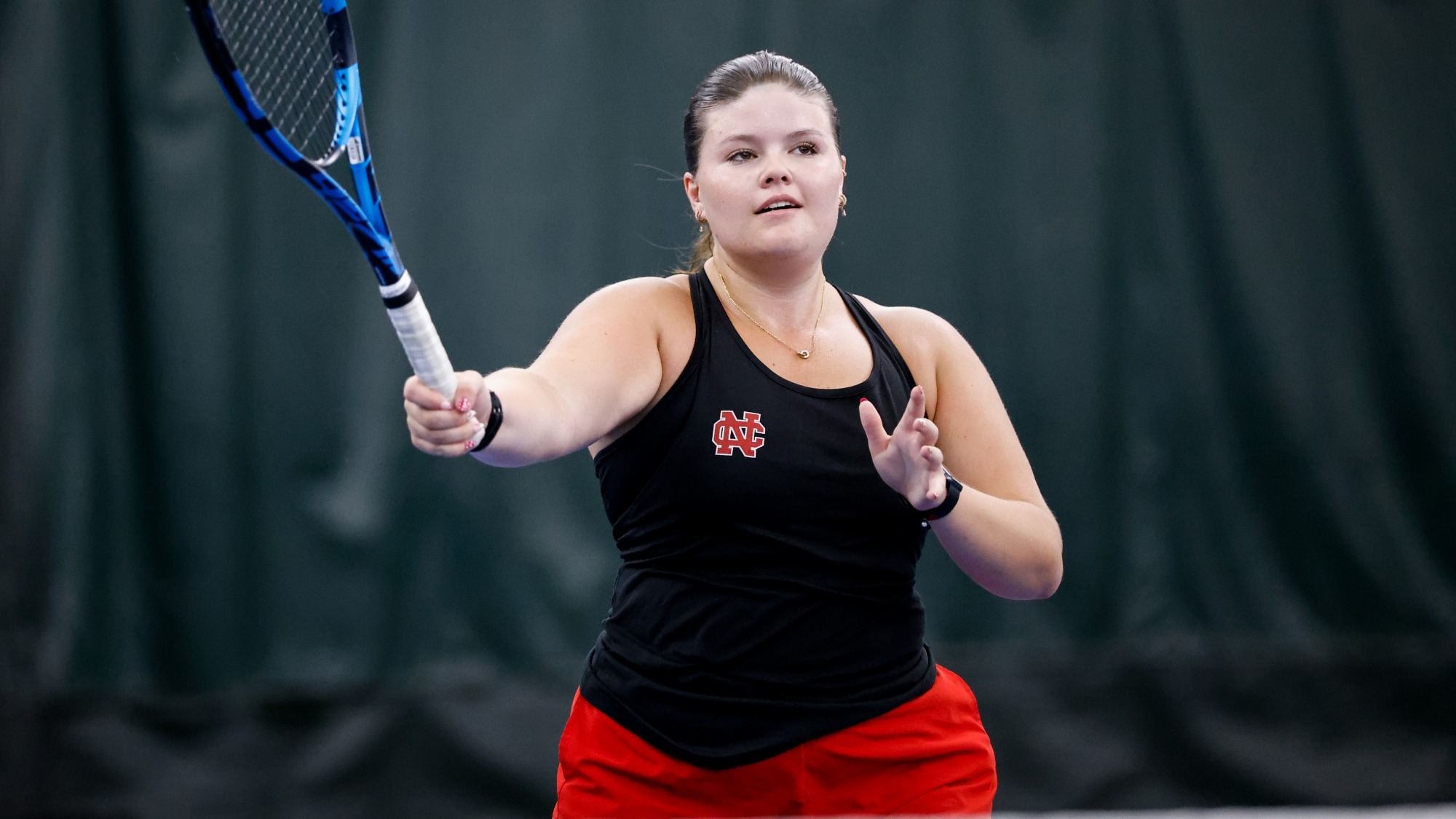 Meghan McSweeney begins a forehanded swing during a practice.