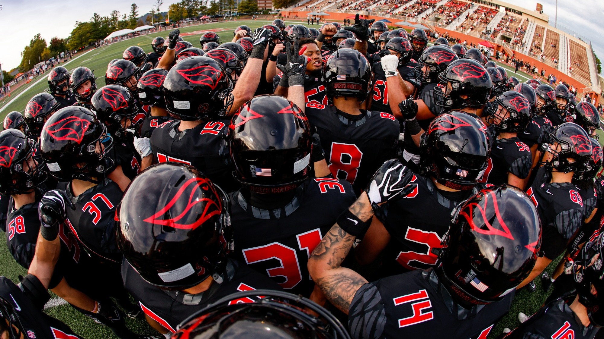 Football Team Huddle before the game vs Wheaton