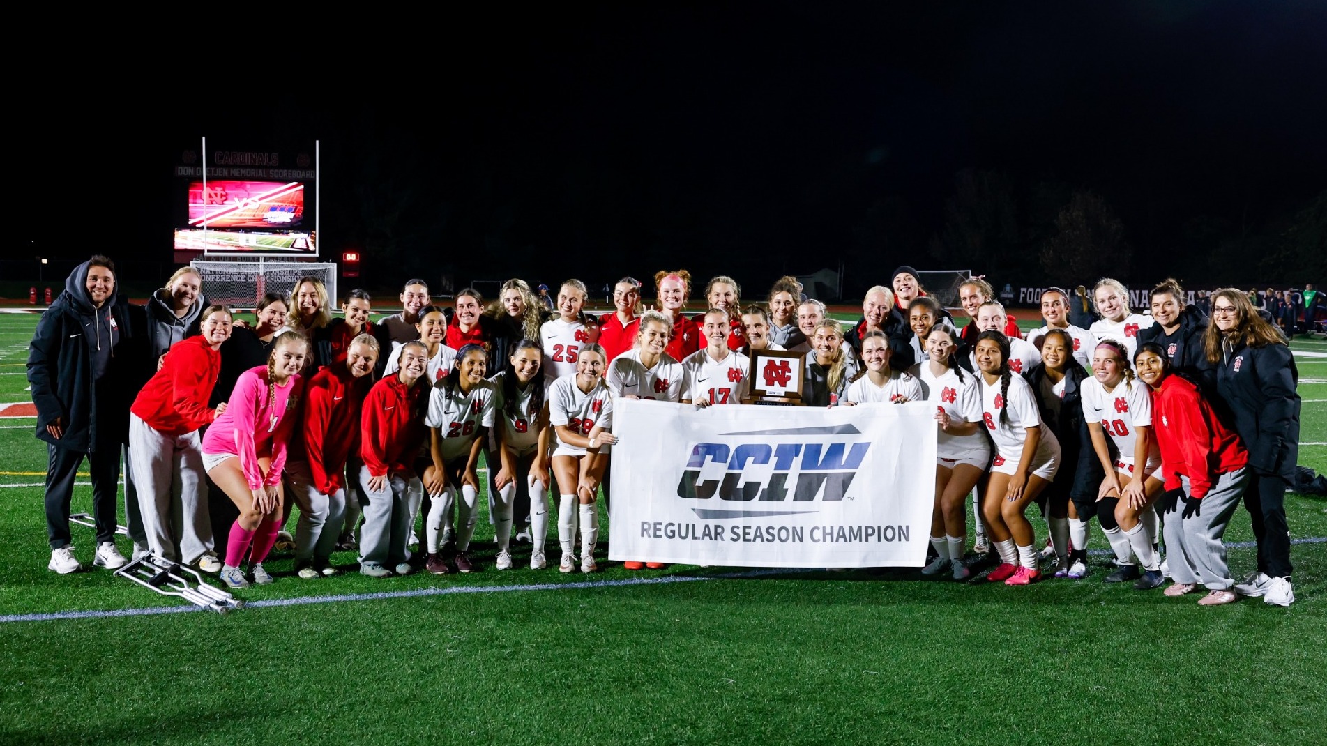 Women's Soccer team with CCIW Regular Season trophy and banner