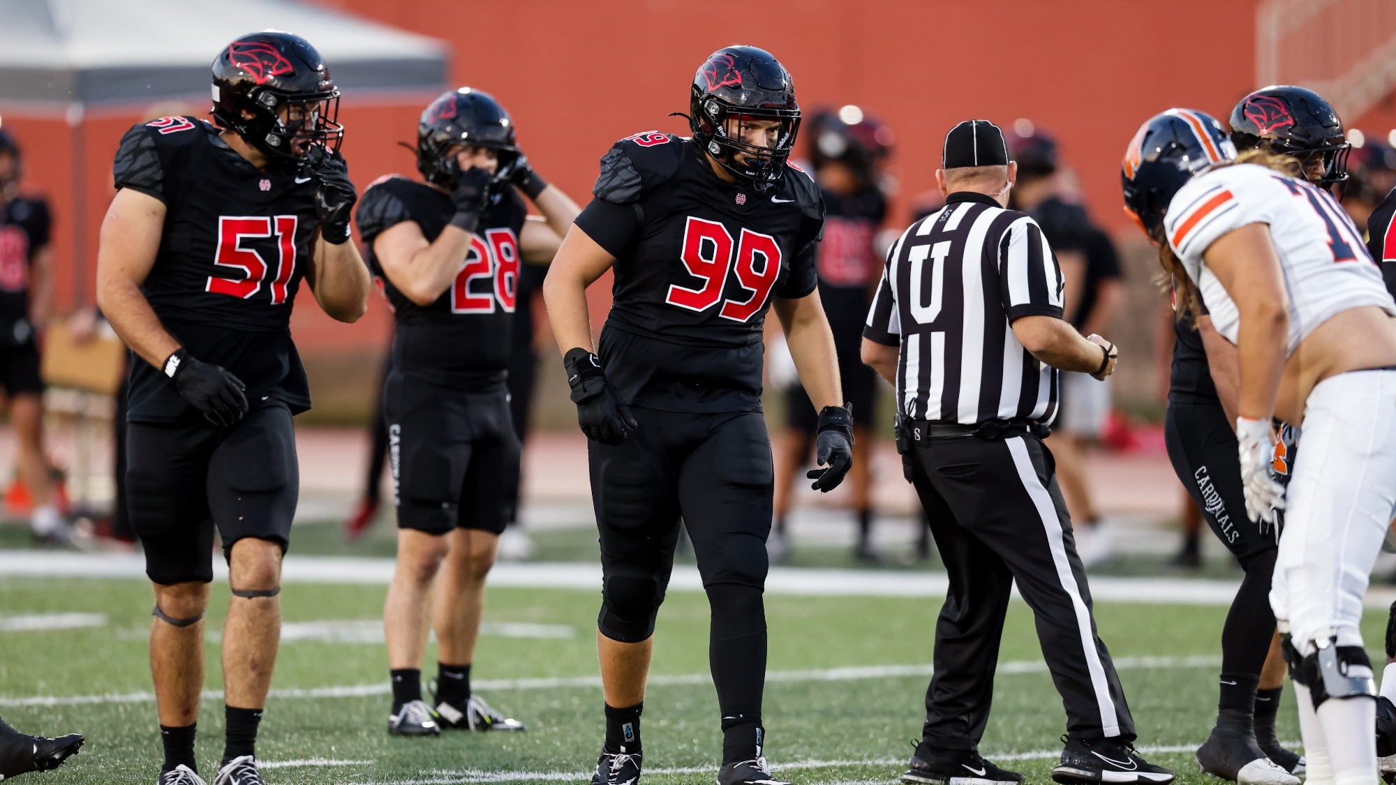 Graham Wight stares down his opponents before a play during a football game