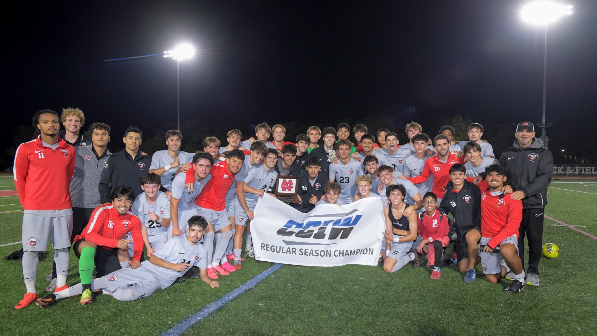 The North Central College men's soccer program celebrating their win against Augustana College and their share of the CCIW regular-season champs title. 