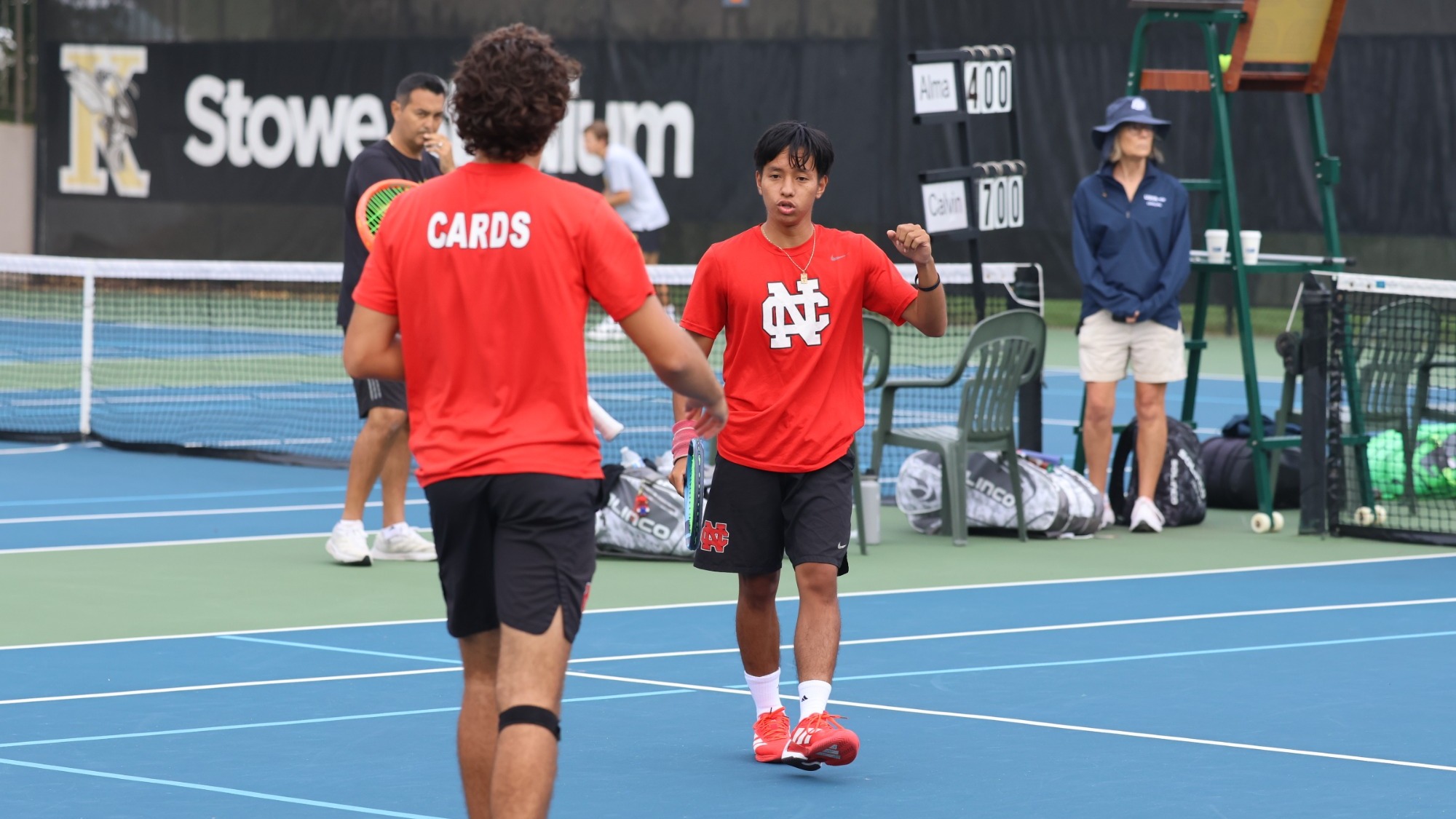 Henry Ros pumps his fist after a point during a doubles match.