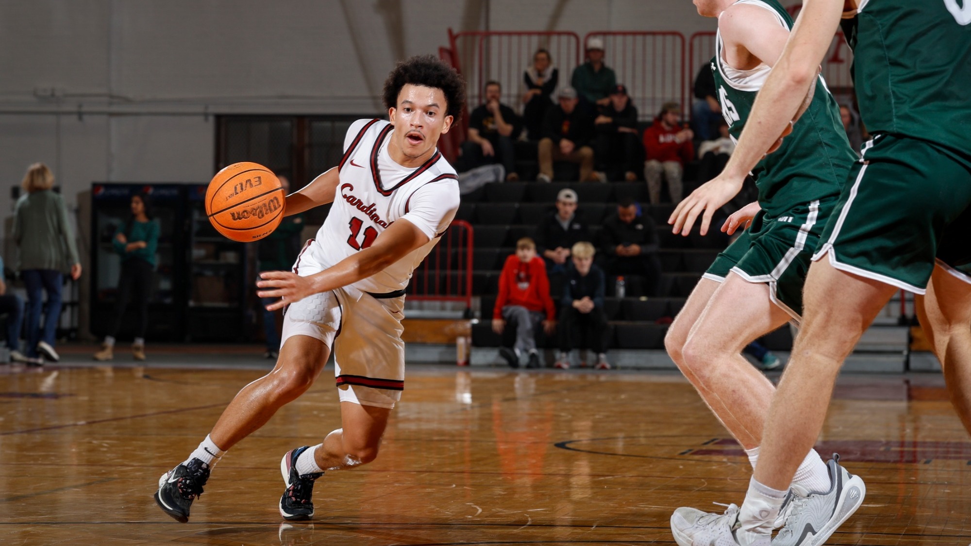 Tre Davis dribbling past an Illinois Wesleyan defender