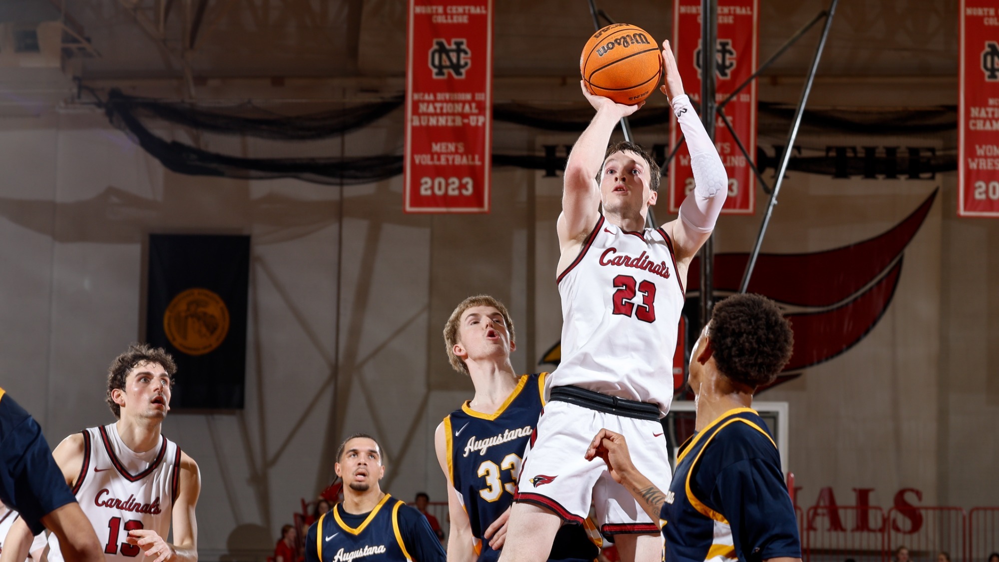 Sean Molloy pulls up for a jump shot over Augustana defenders