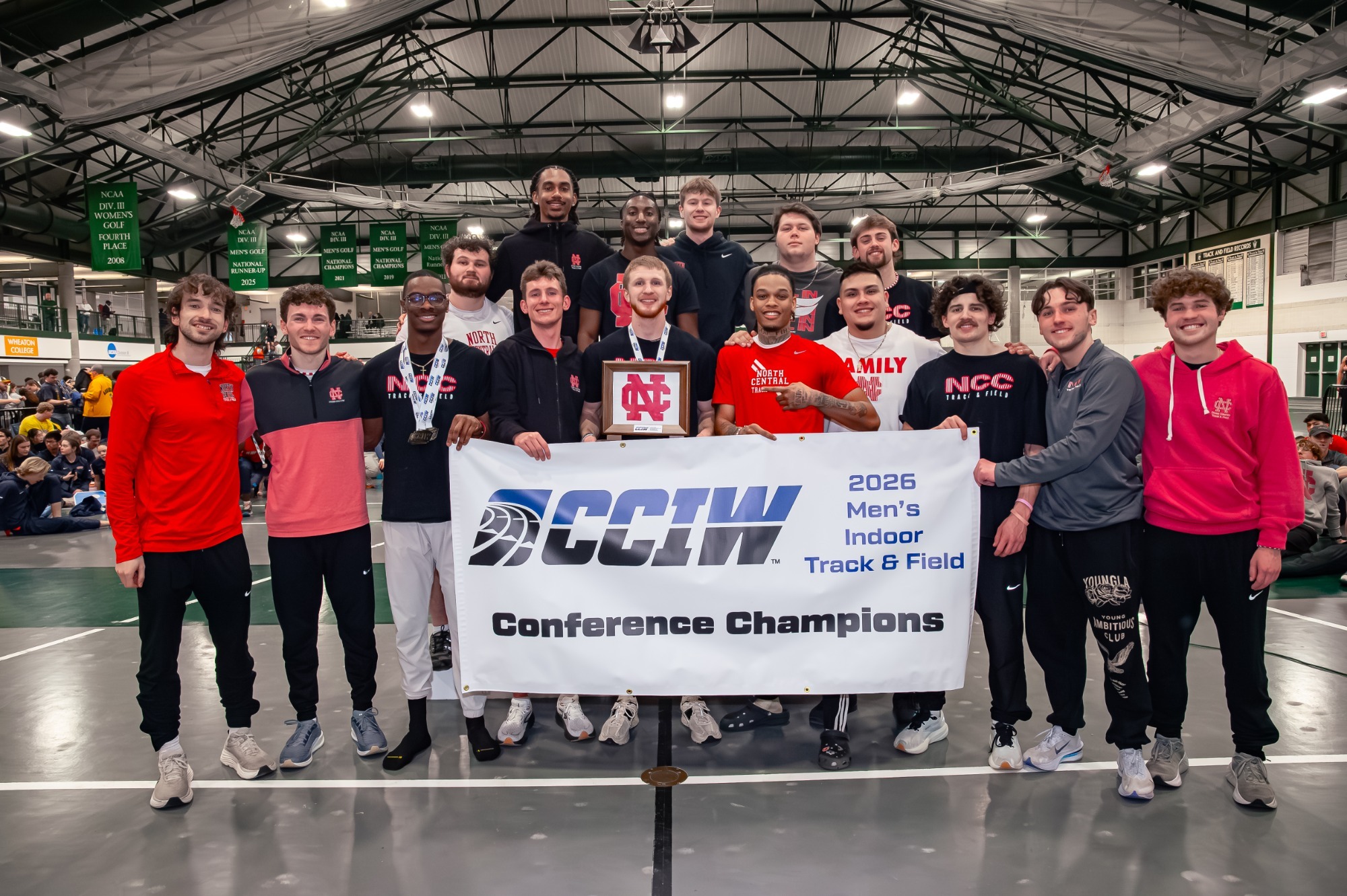 Men's Track & Field seniors pose with CCIW Champion trophy and banner
